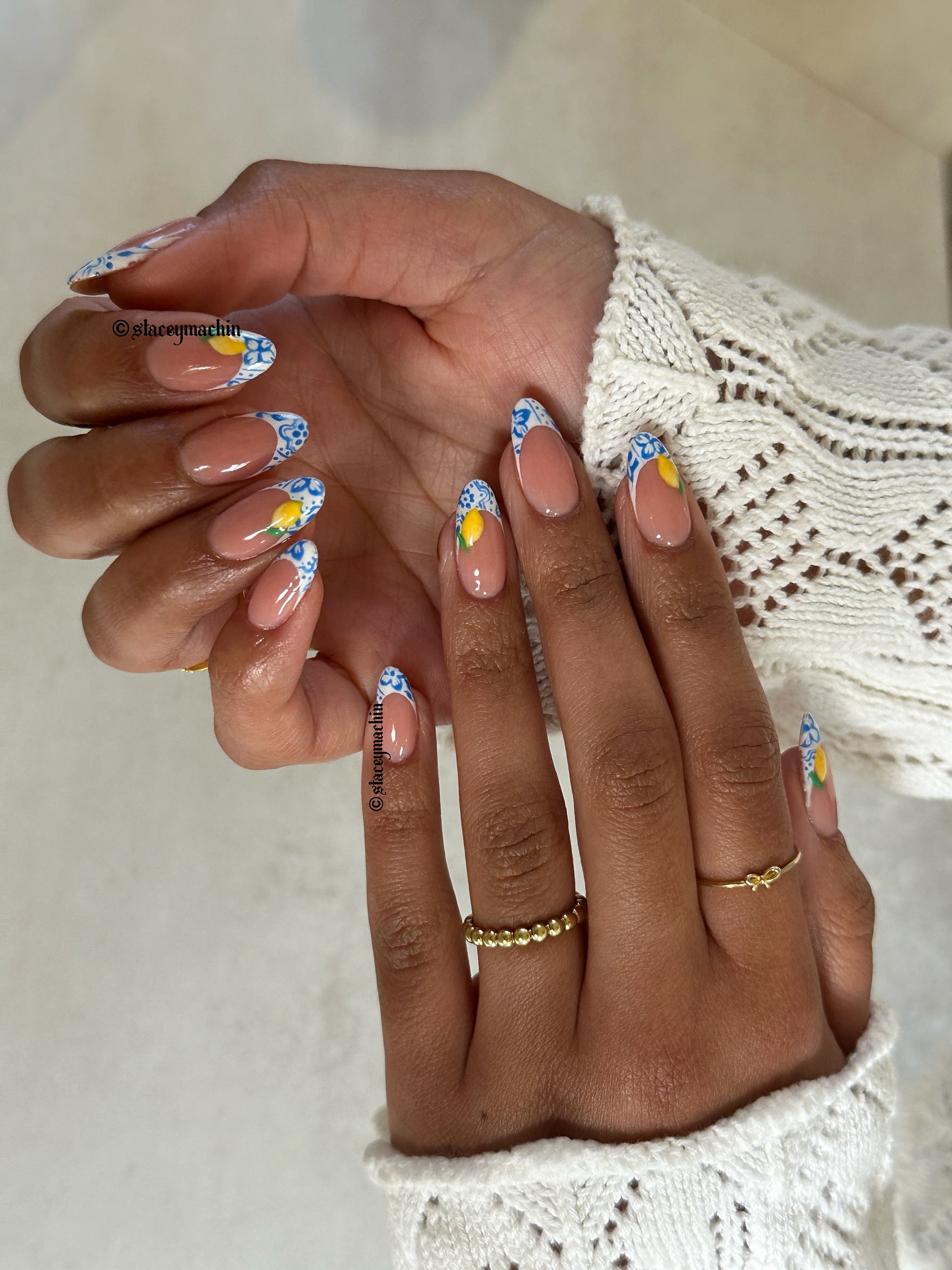 Nude almond nails with blue tile French tips and lemon accents