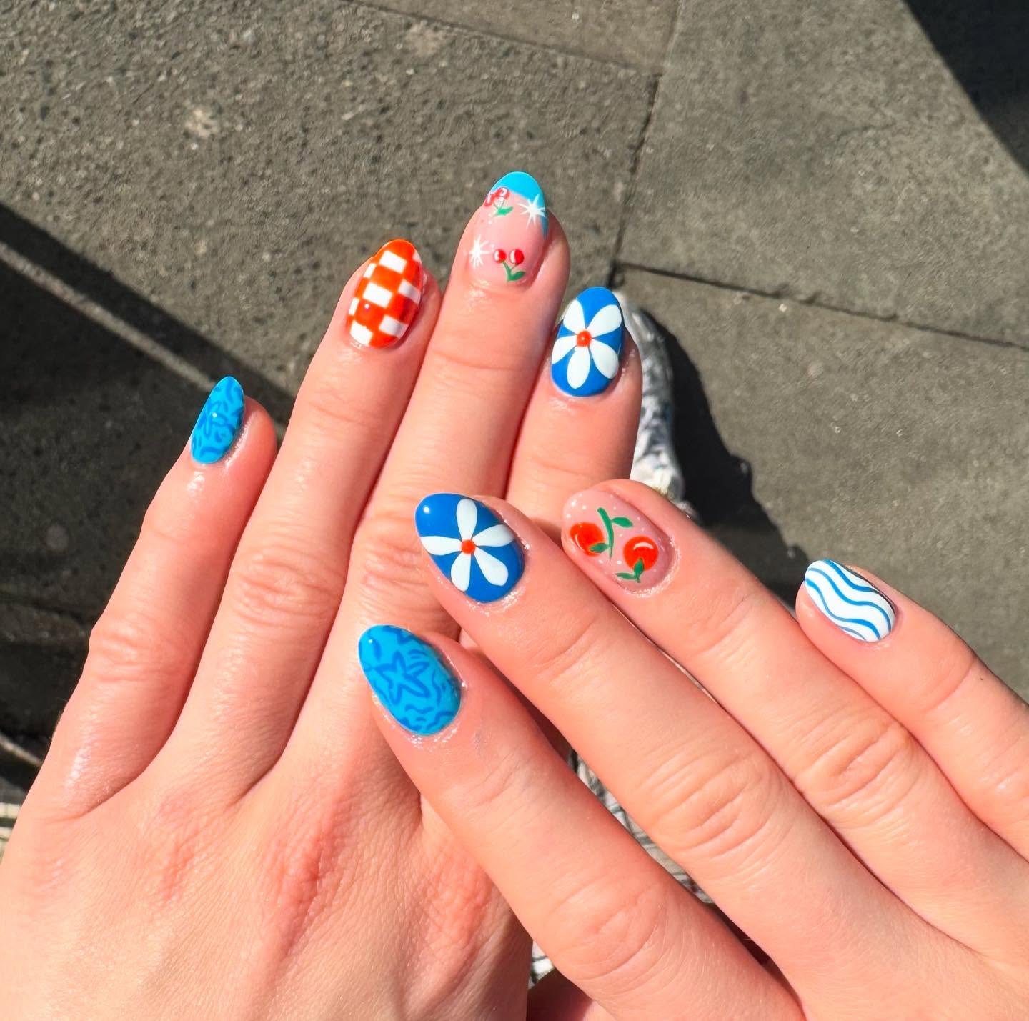 Blue and orange mismatched daisy nail designs