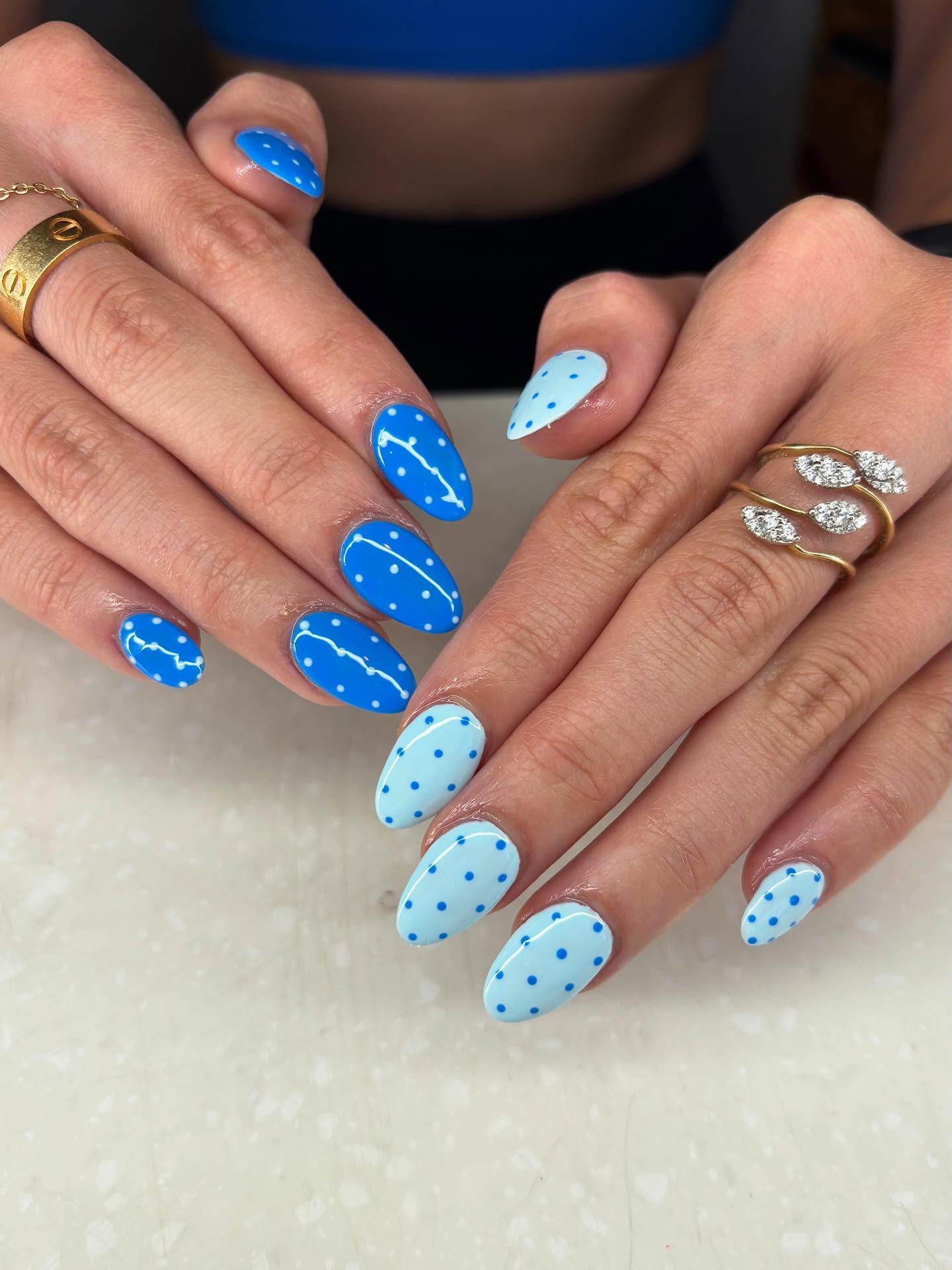 Royal and baby blue almond nails with dots and constellations