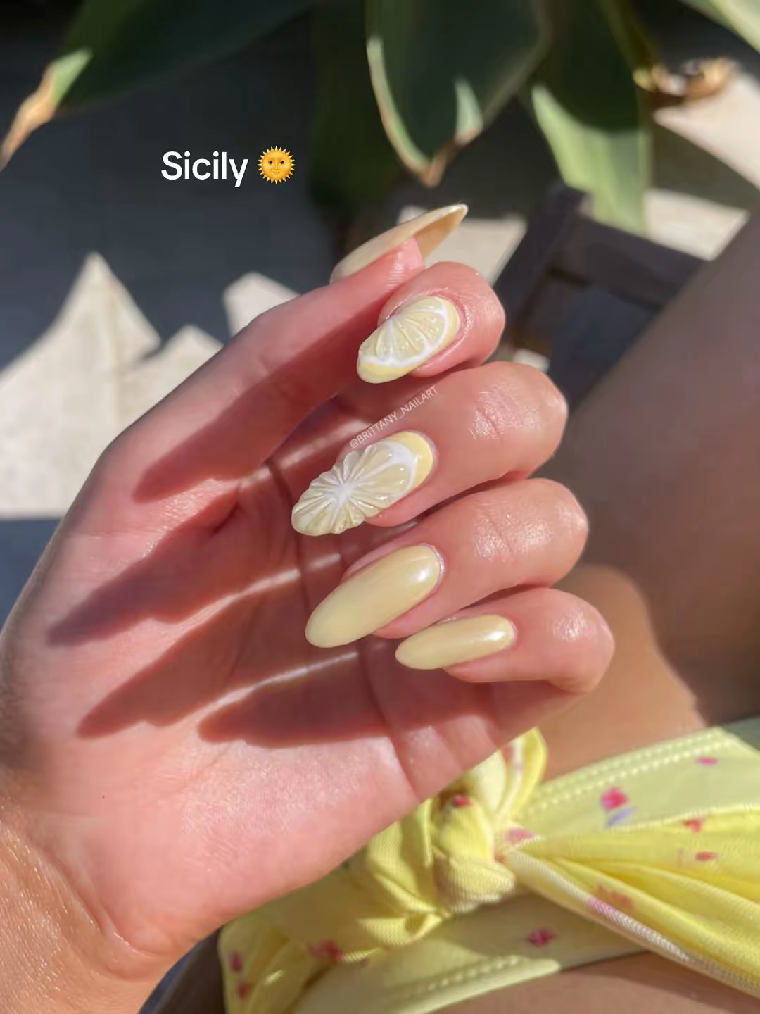 Butter yellow almond nails with lemon slice accent in Sicily