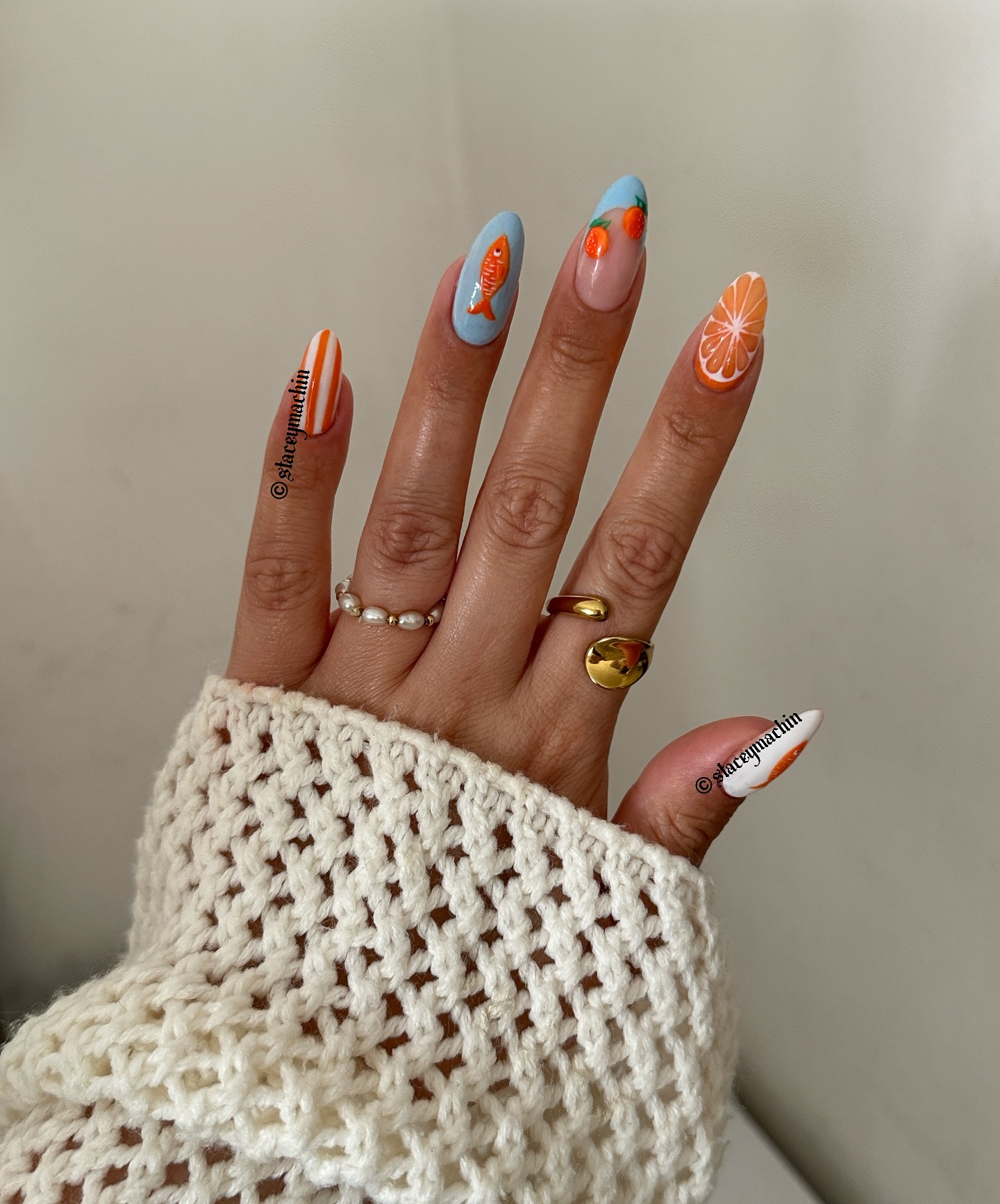 Mismatched almond nails with citrus fish and stripe designs