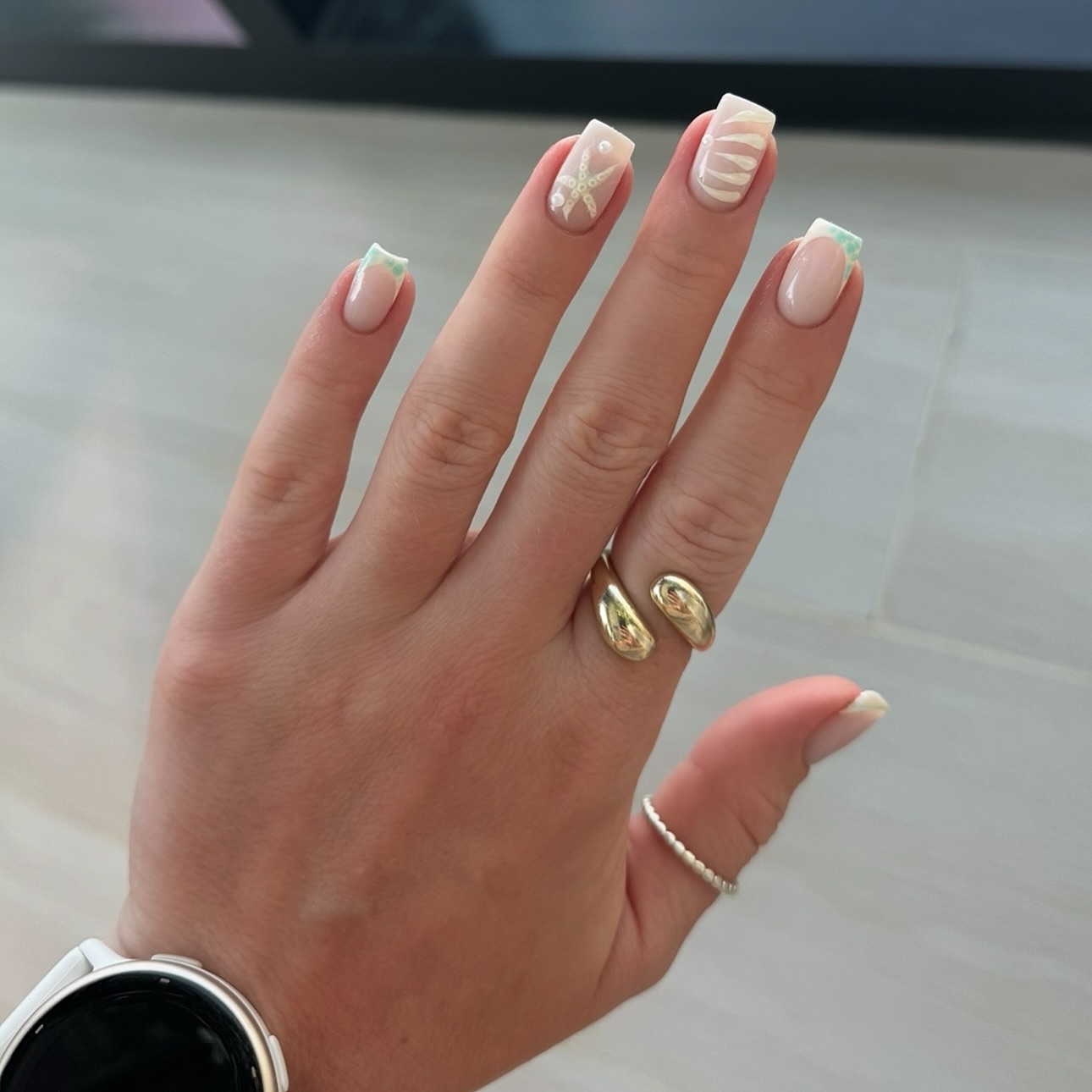 Square nude nails with mint French tips, sculpted white starfish and seashell art