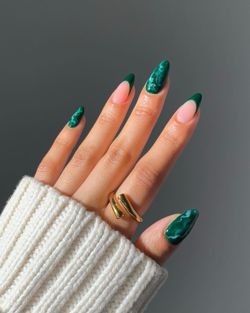 Dark emerald green almond nails with malachite stone swirl pattern
