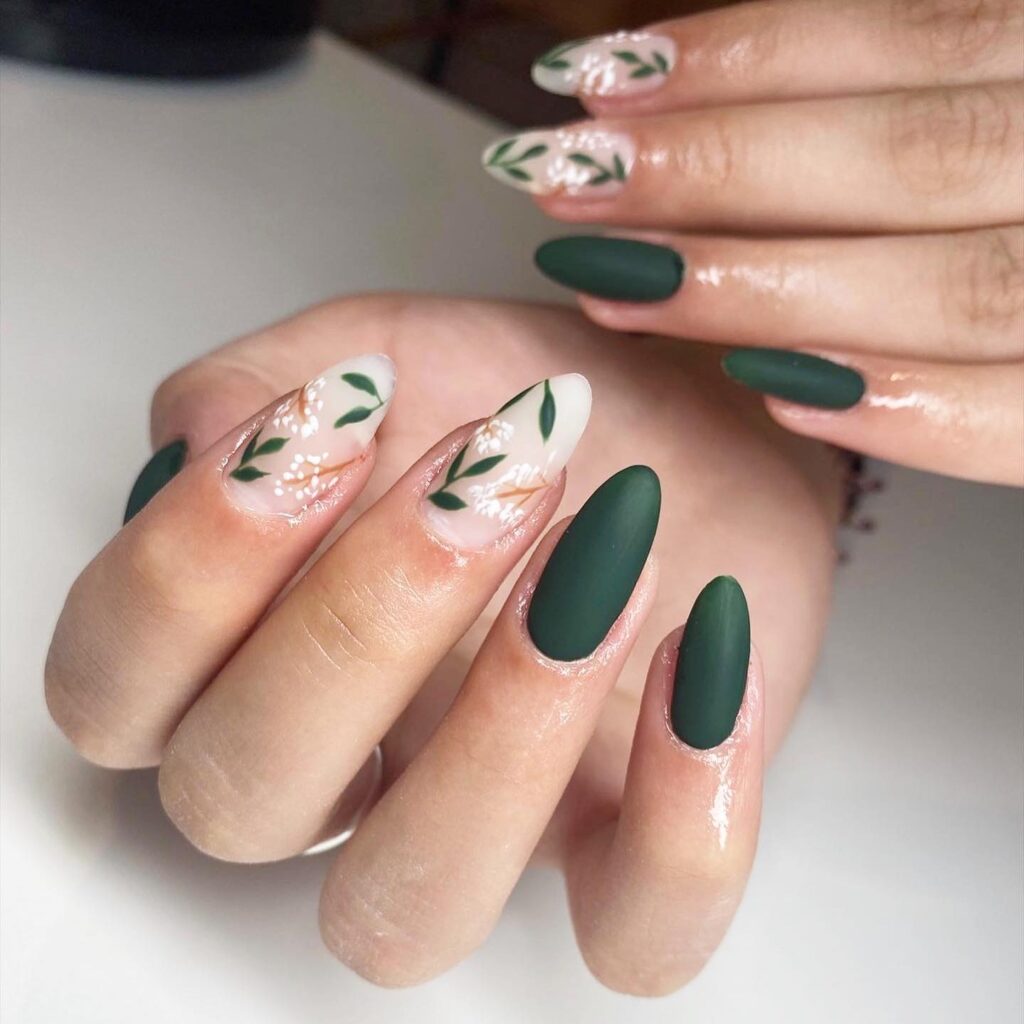Dark green matte nails with botanical leaf sprigs and white flower art

