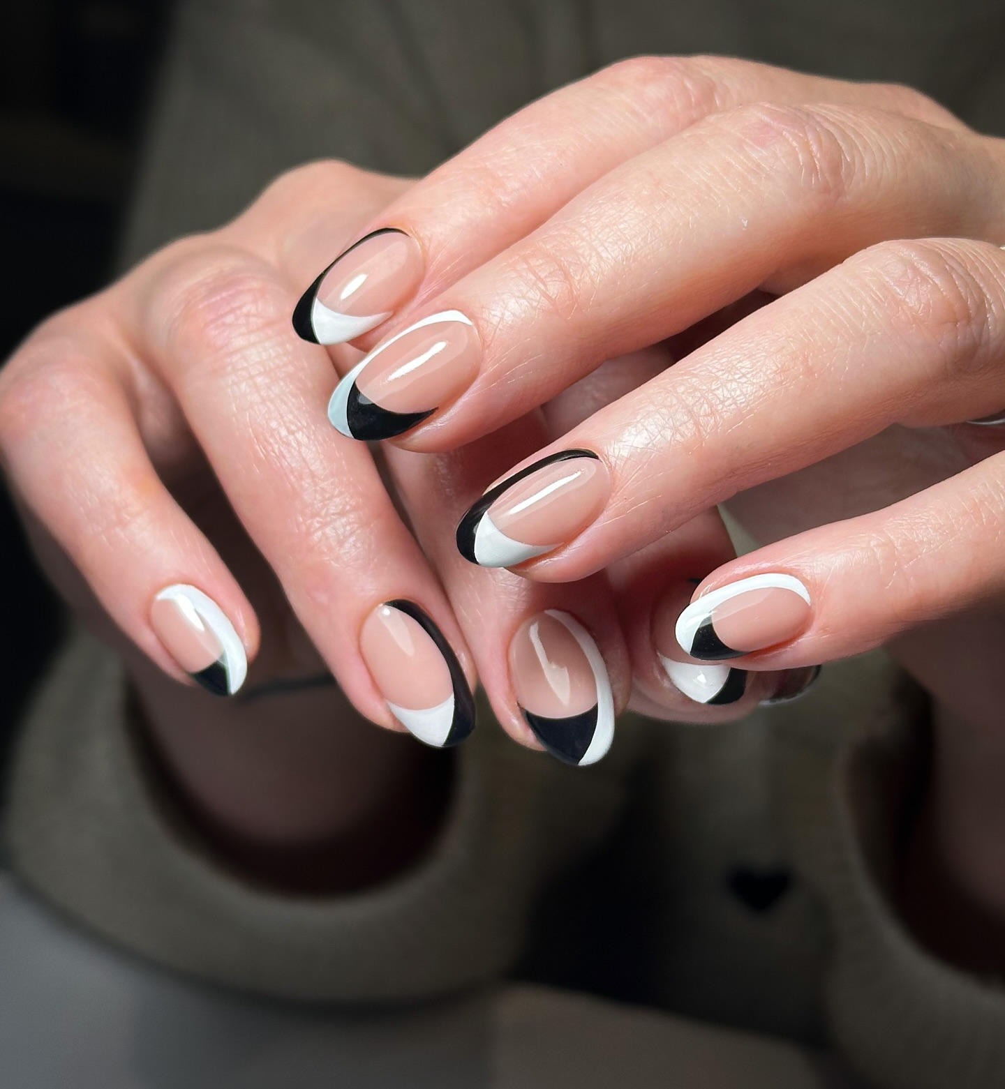 Almond nails with alternating black and white French tips
