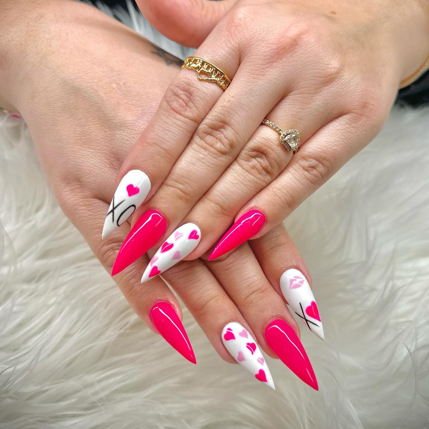 Extra long stiletto nails in hot pink and white with XO lettering hearts and lip prints
