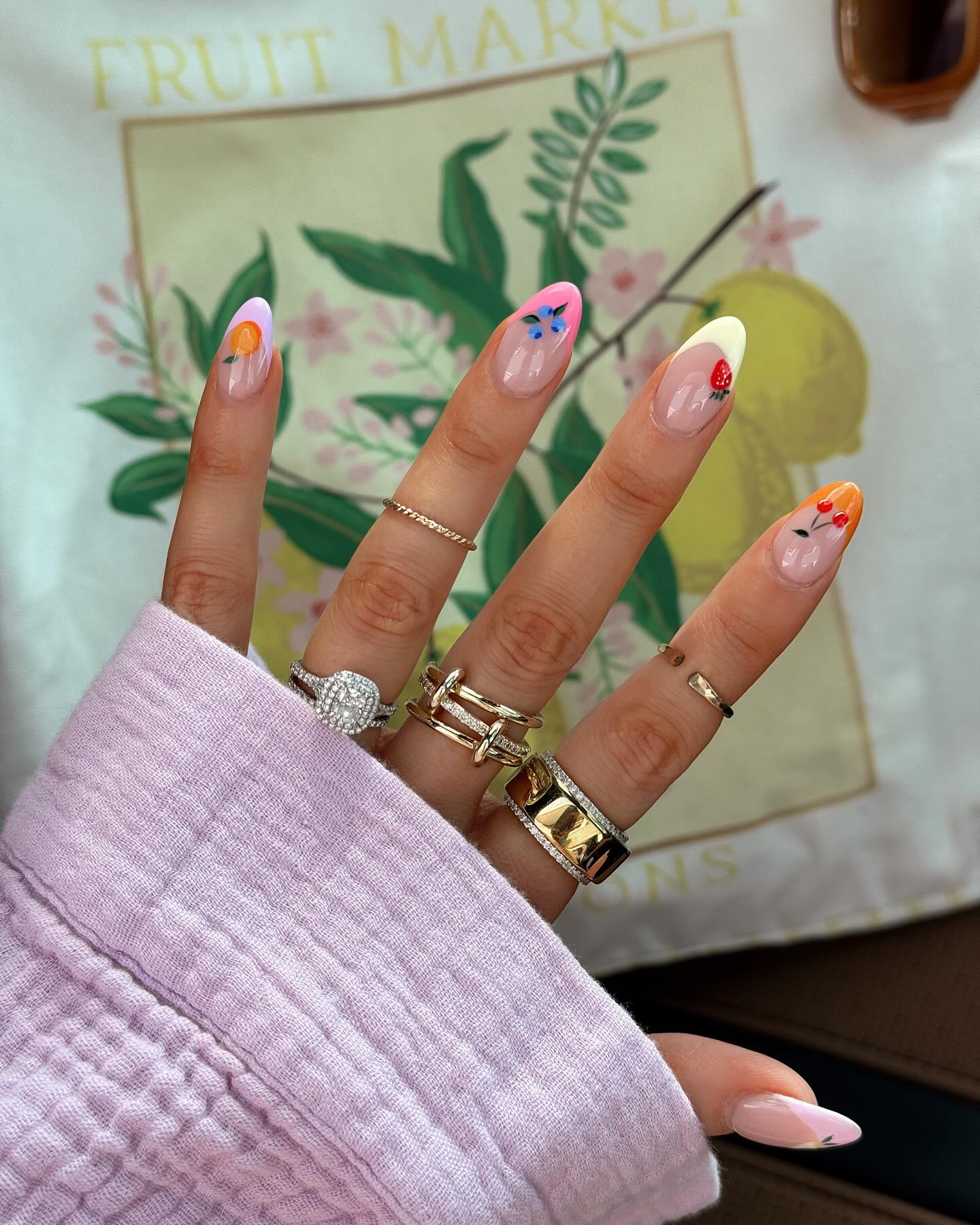 Sheer almond nails with cherry strawberry and orange fruit art
