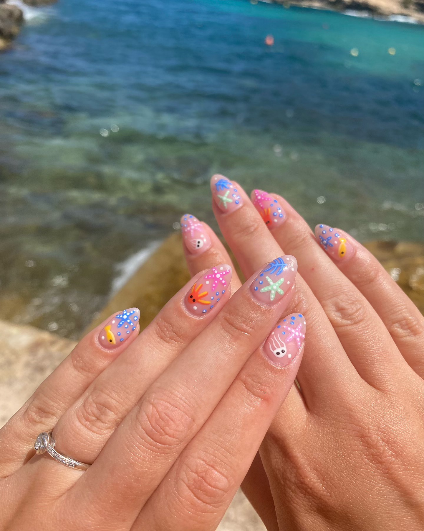 Sheer nails with painted starfish, jellyfish, tropical fish and coral