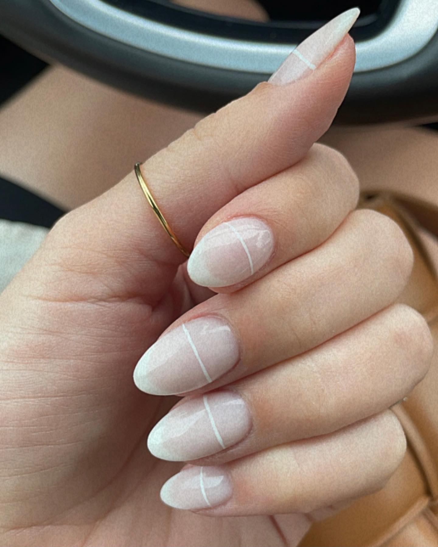 Glazed nude almond nails with delicate white grid line detail