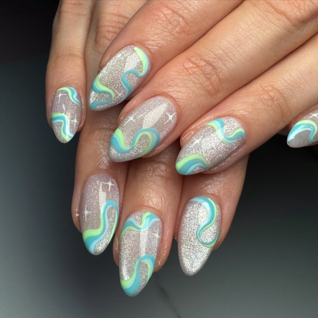 silver glitter nails with teal and lime green wave swirls