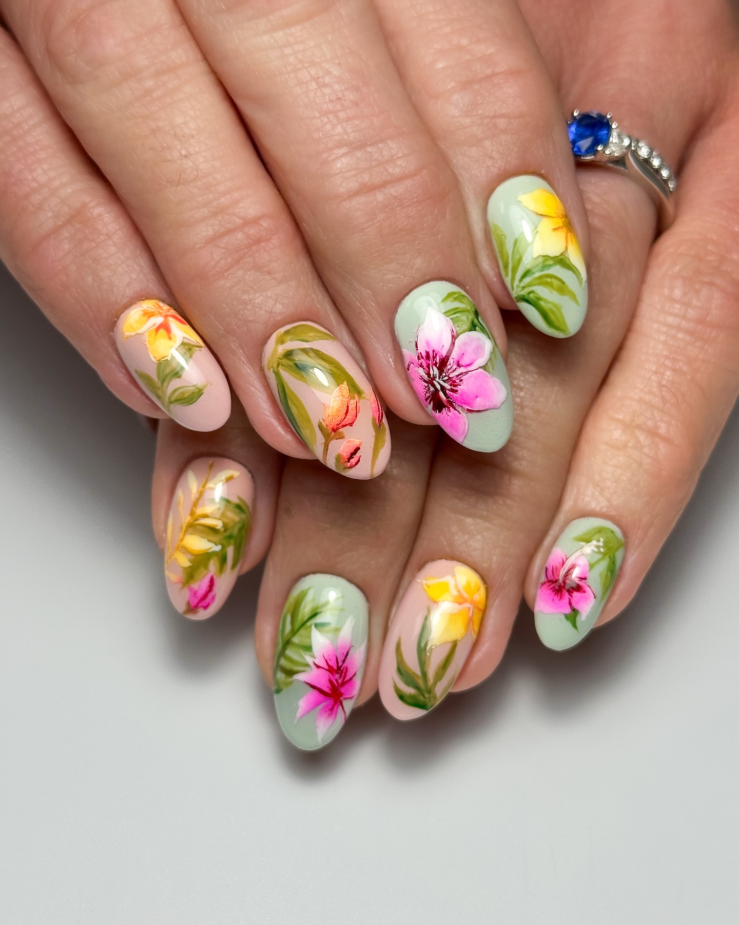 Hand-painted tropical botanical florals on sage green almond nails