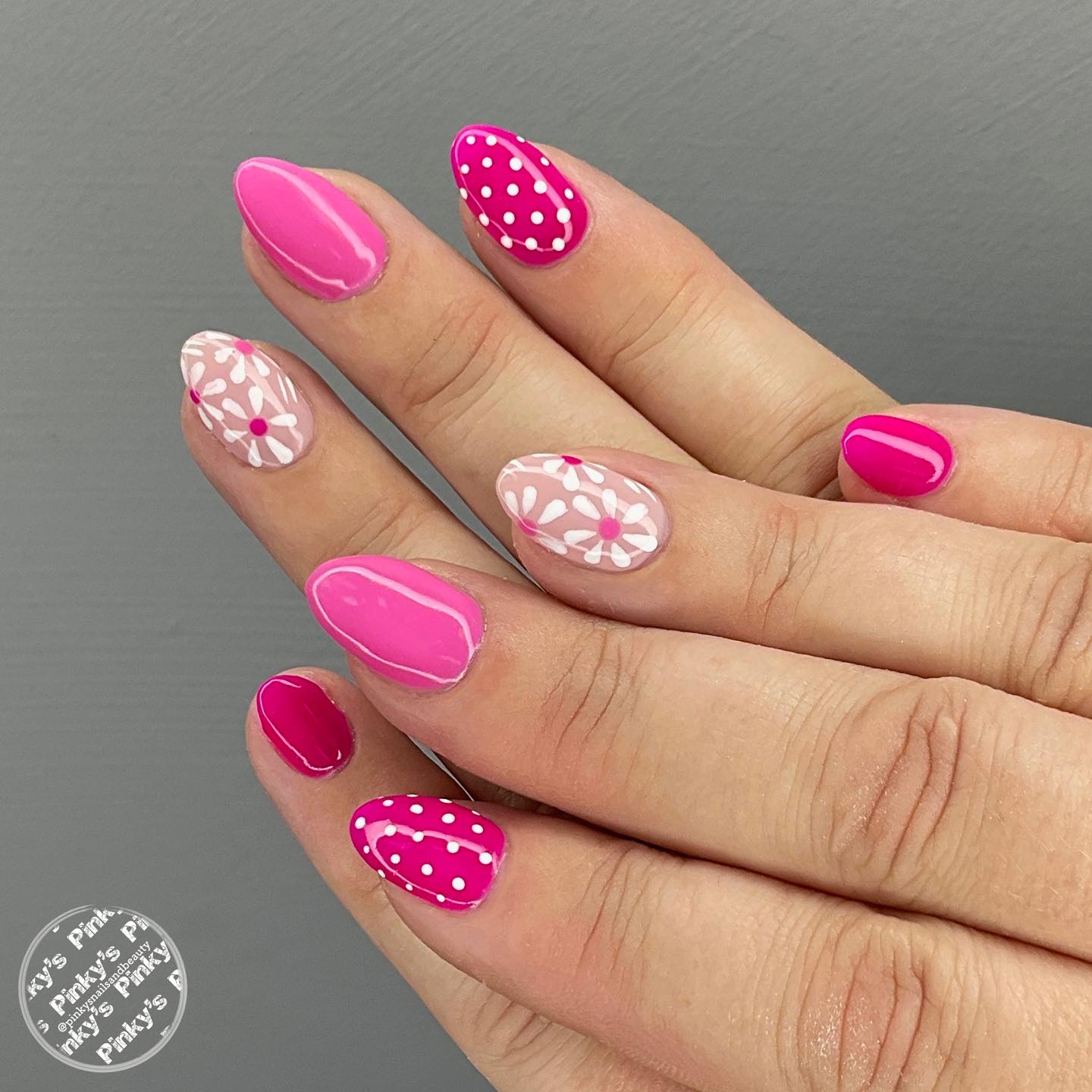 Hot pink nails with white daisy art and polka dot accents