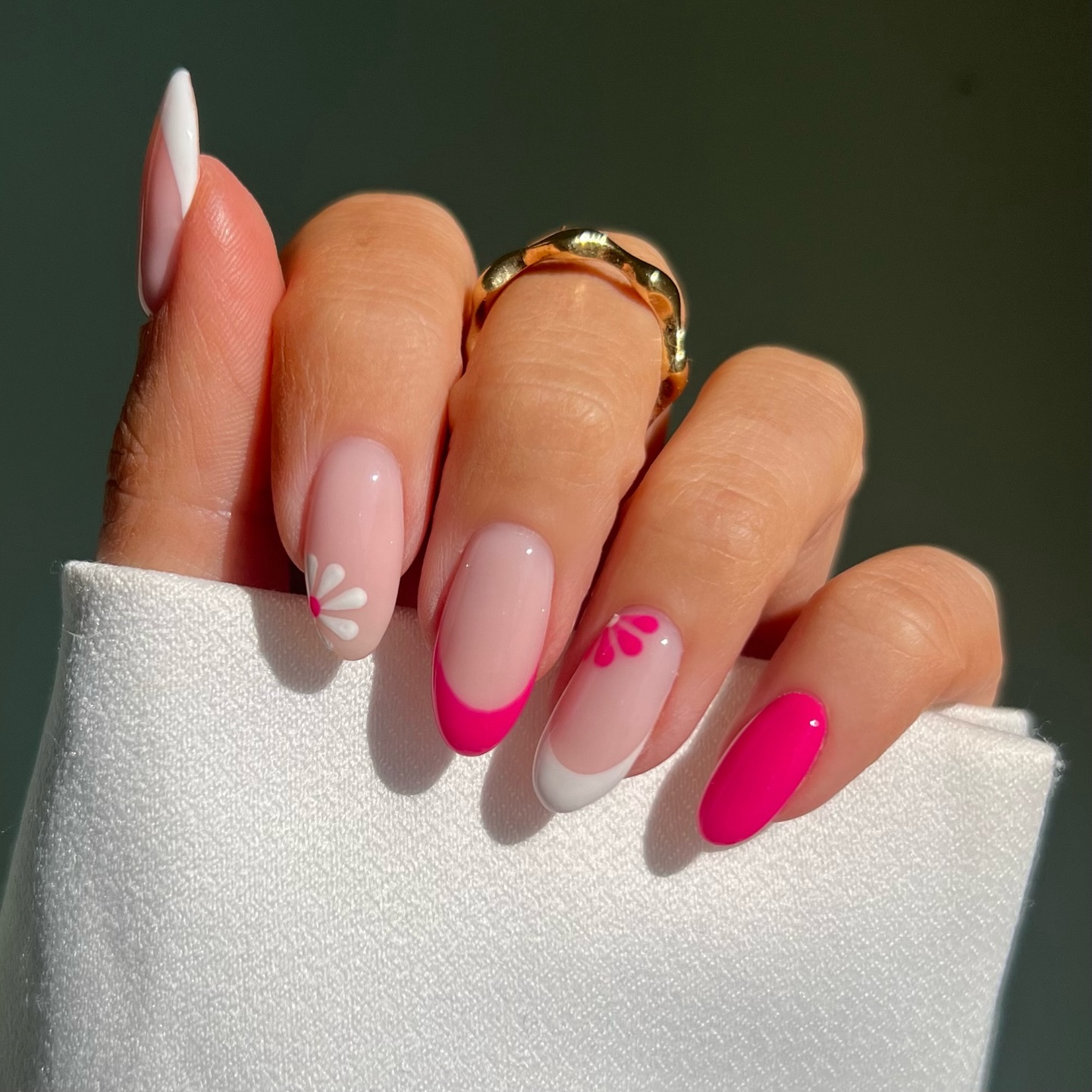 Almond nails with classic white tip hot pink French tips and sheer floral accent nail