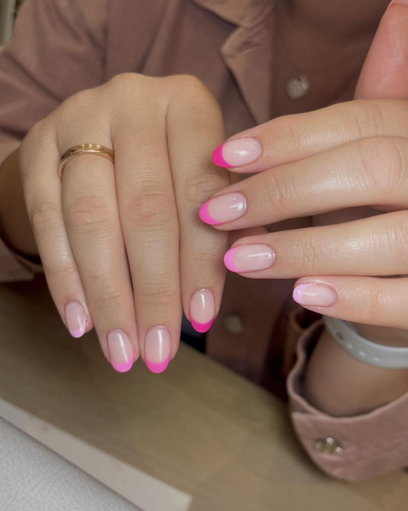 Sheer nude nails with hot pink French tips
