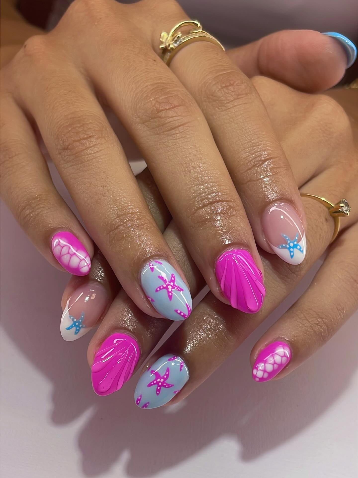 Hot pink and blue nails with raised clamshells and starfish