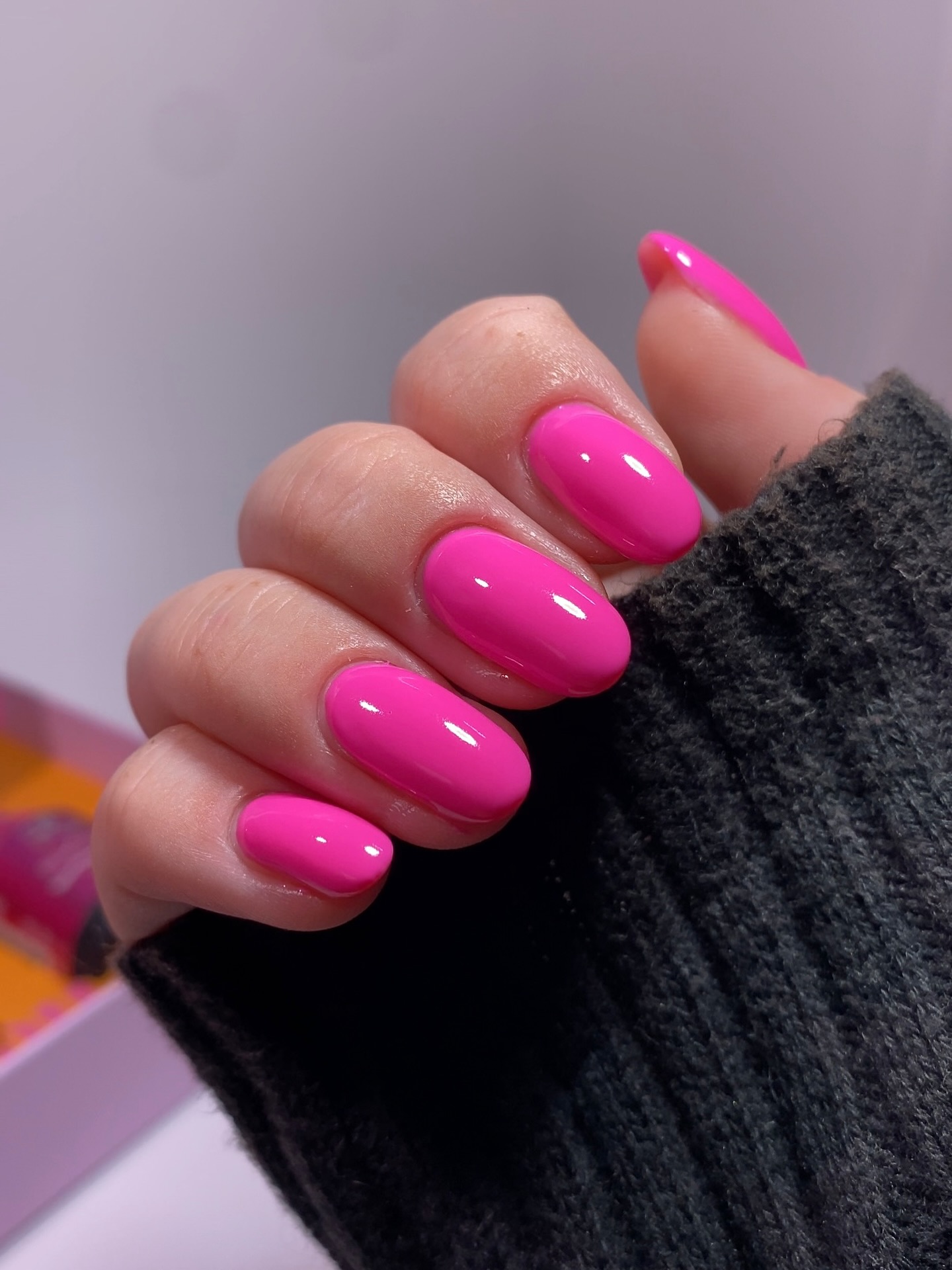Hot pink solid gel nails on short rounded nails