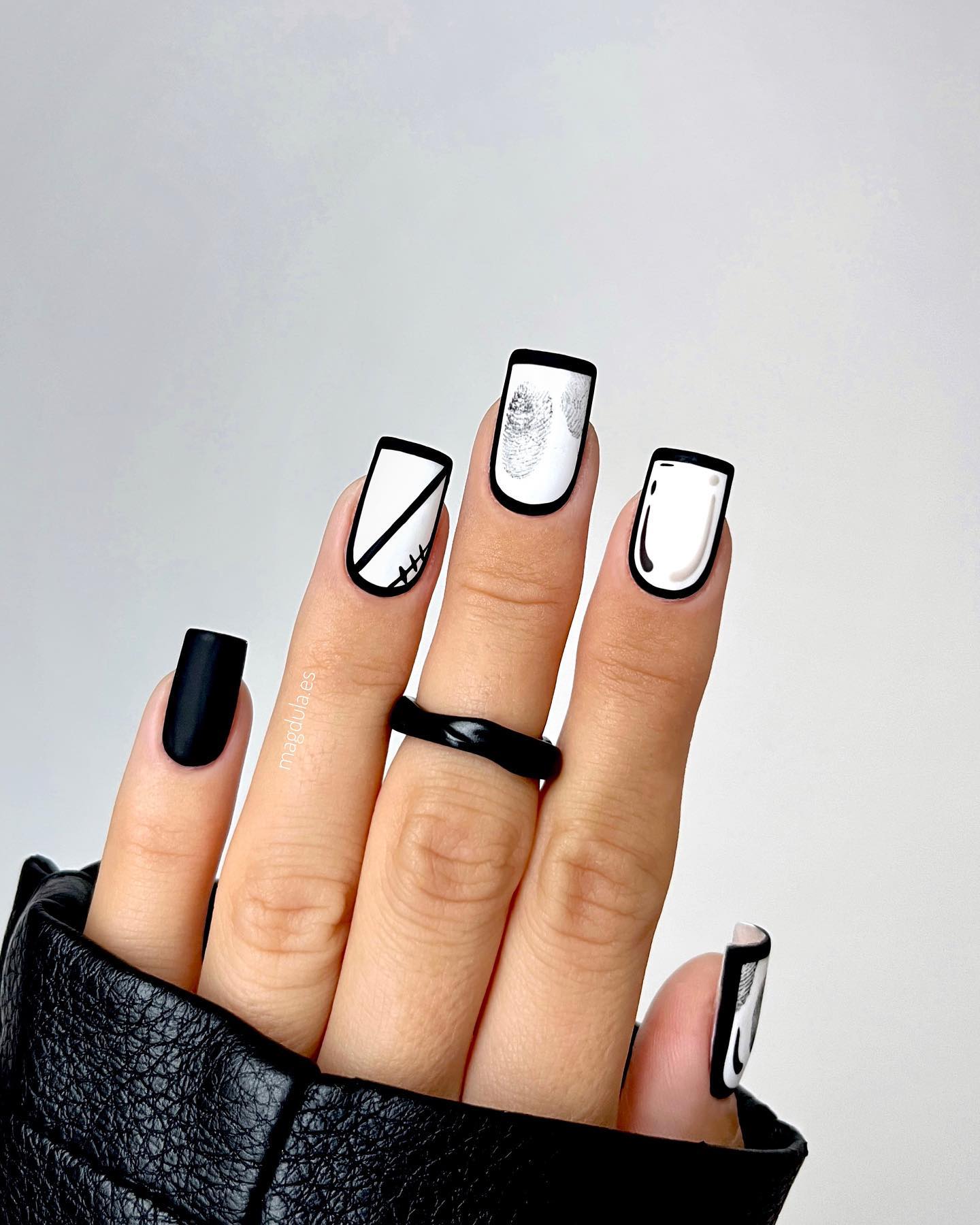 Matte black and white nails with comic-book style graphic art