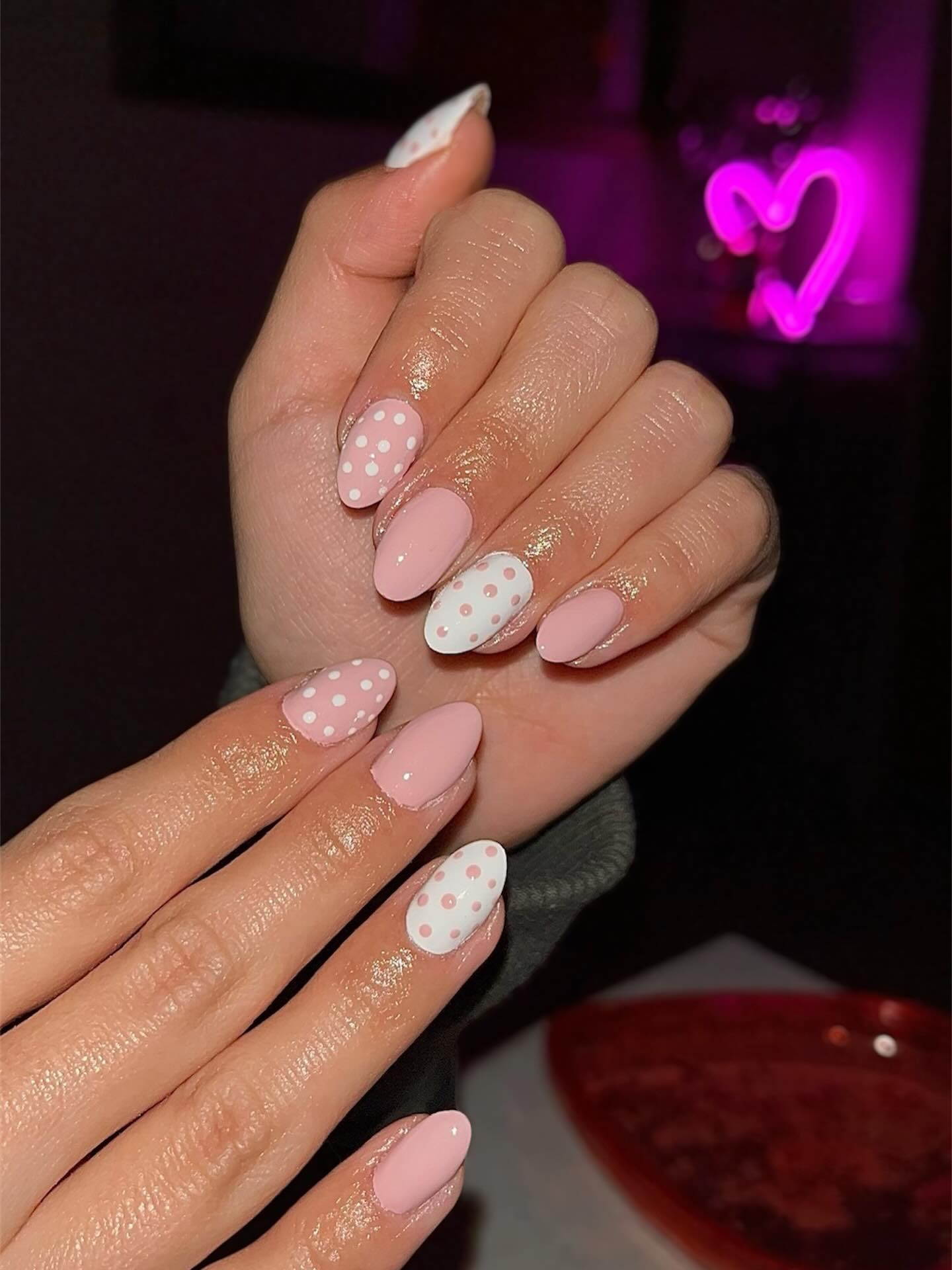 Matte pink and white polka dot alternating almond nails