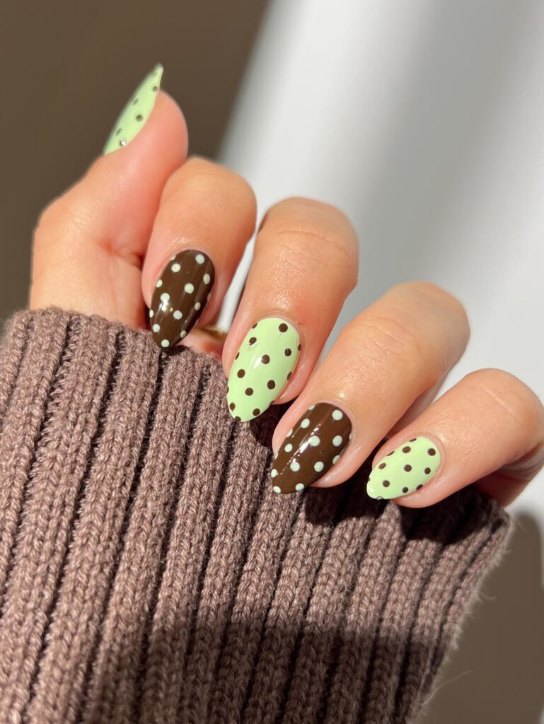 Long almond nails alternating mint green and chocolate brown polka dot pattern
