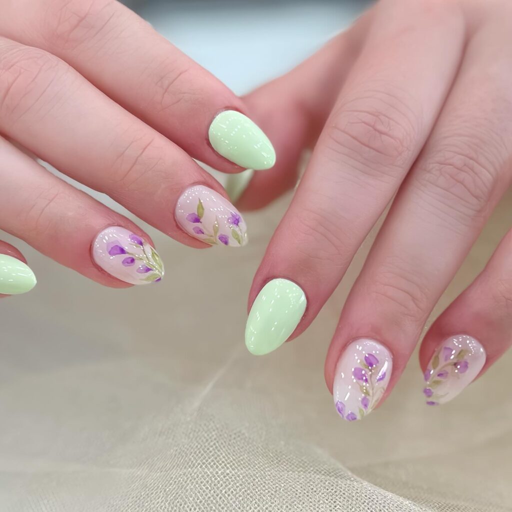 Mint green nails with sheer accent nails featuring soft purple watercolor florals
