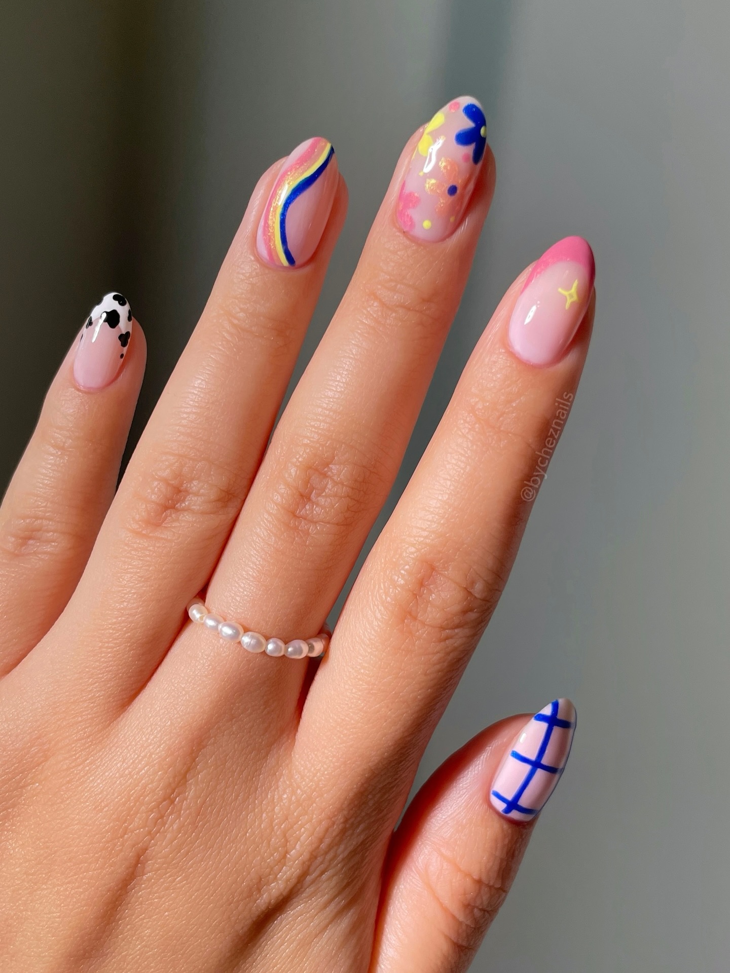 Cow print swirl floral and grid pattern almond nails