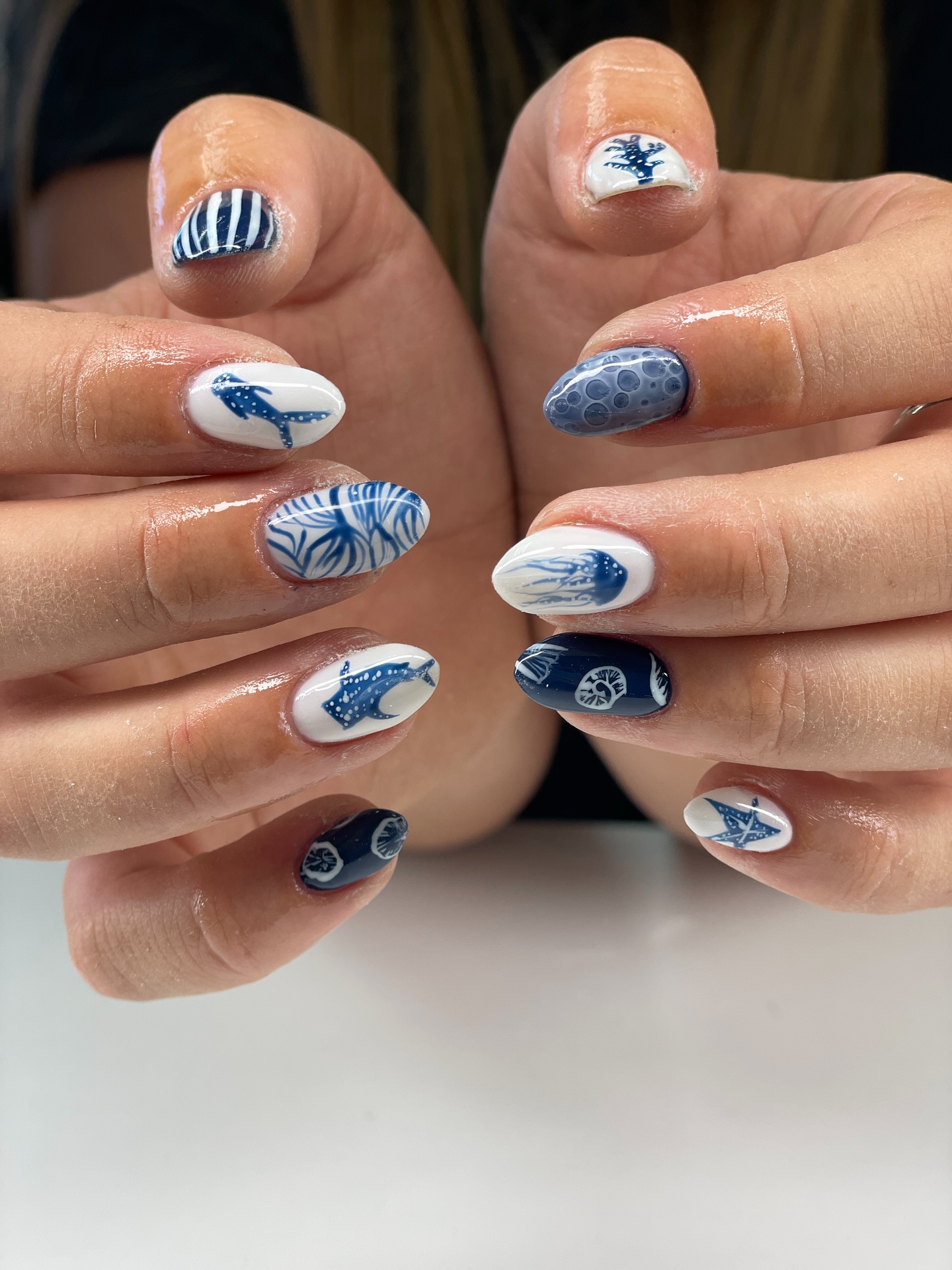 Navy and white almond nails with whale shark and jellyfish art