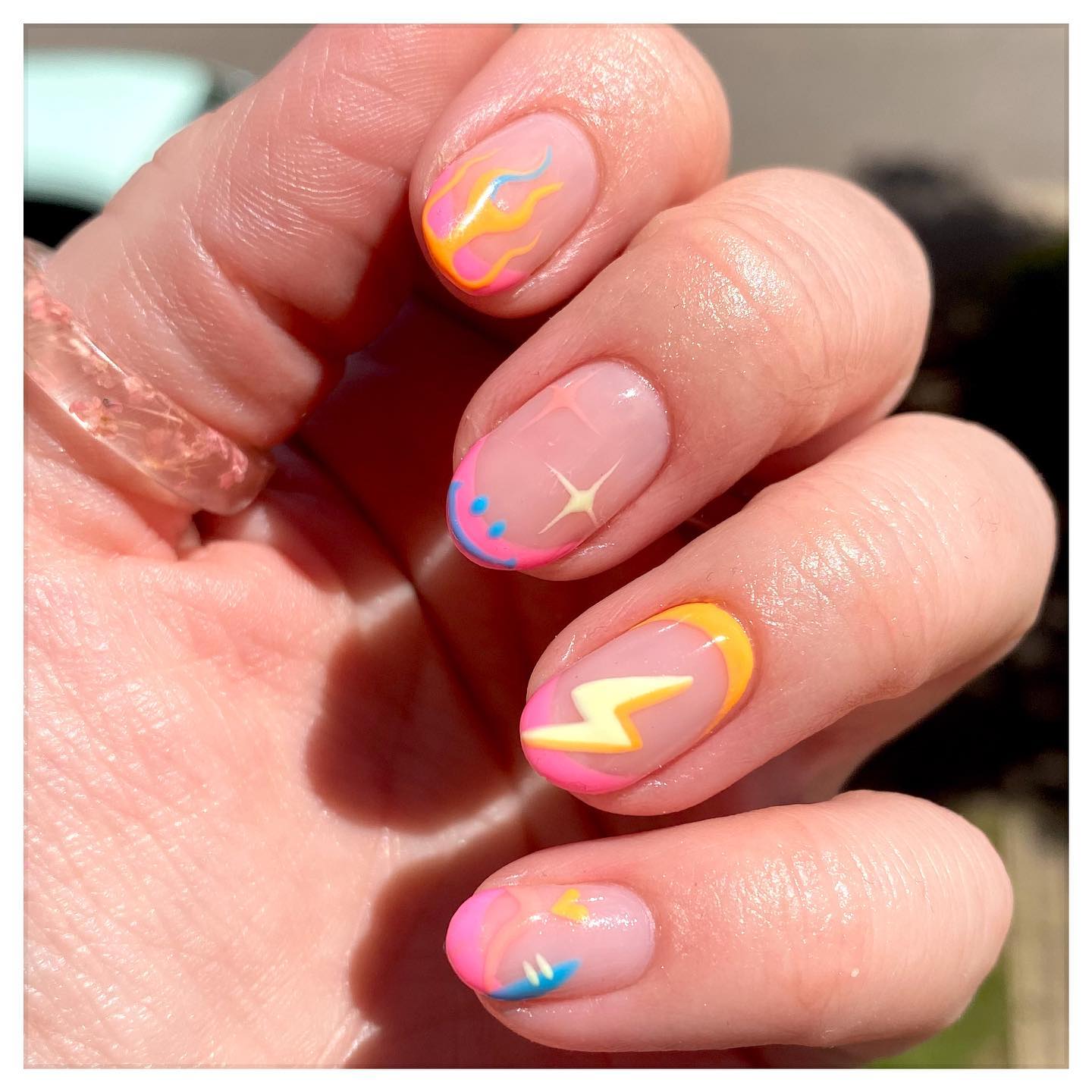 Neon flame and lightning bolt nail art design
