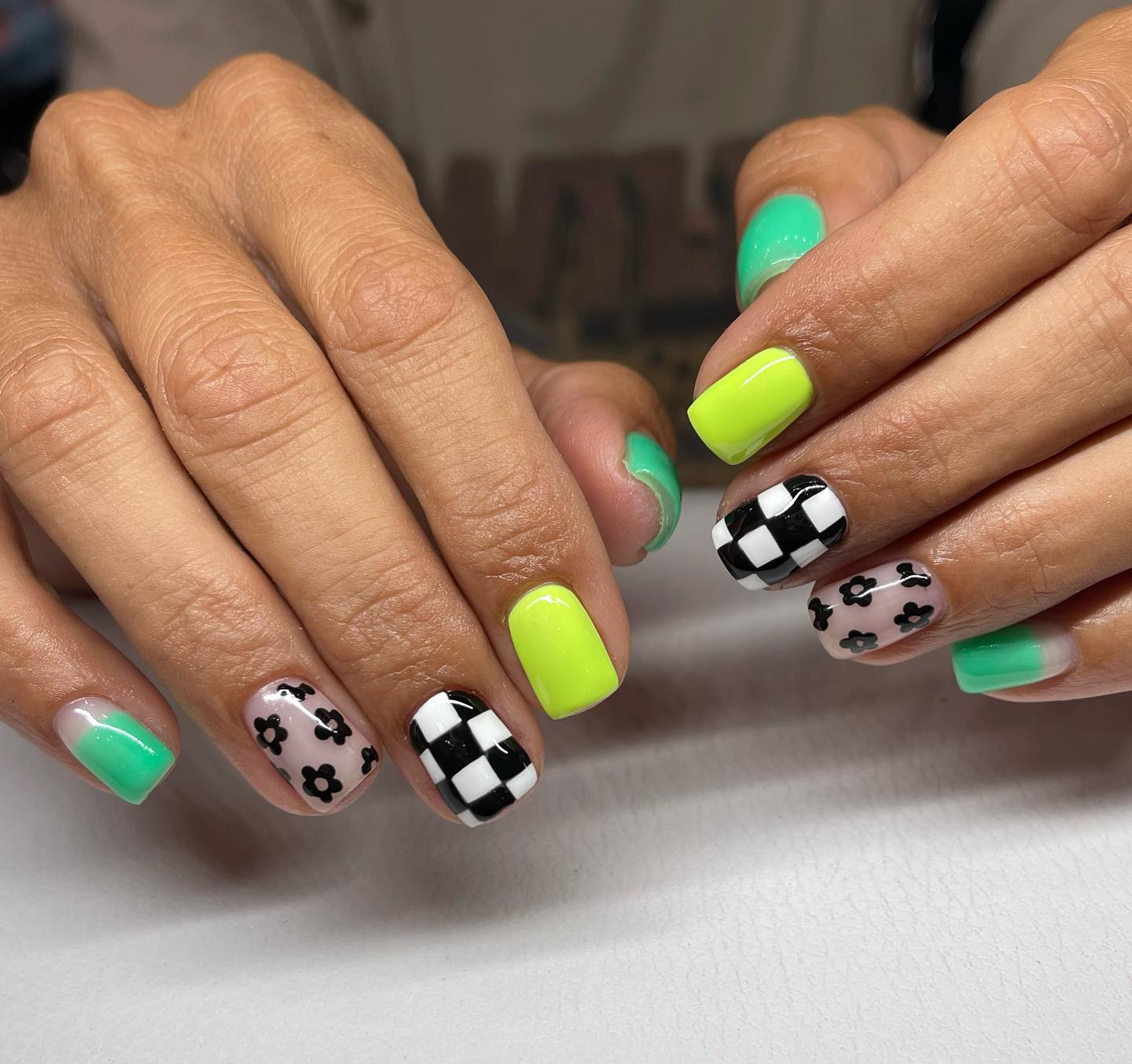 Neon green checker daisy nails