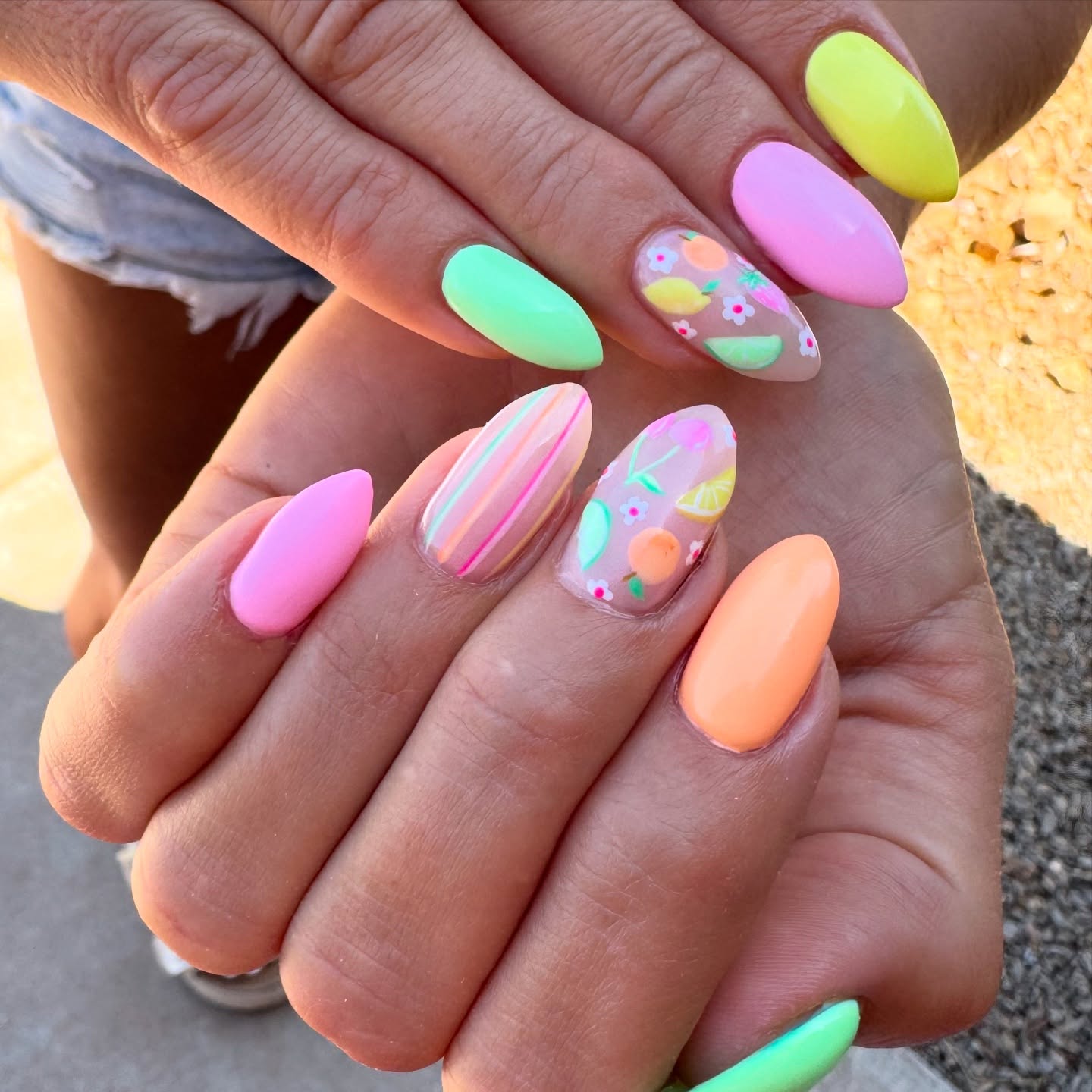 Neon pastel almond nails in pink mint yellow with fruit accents