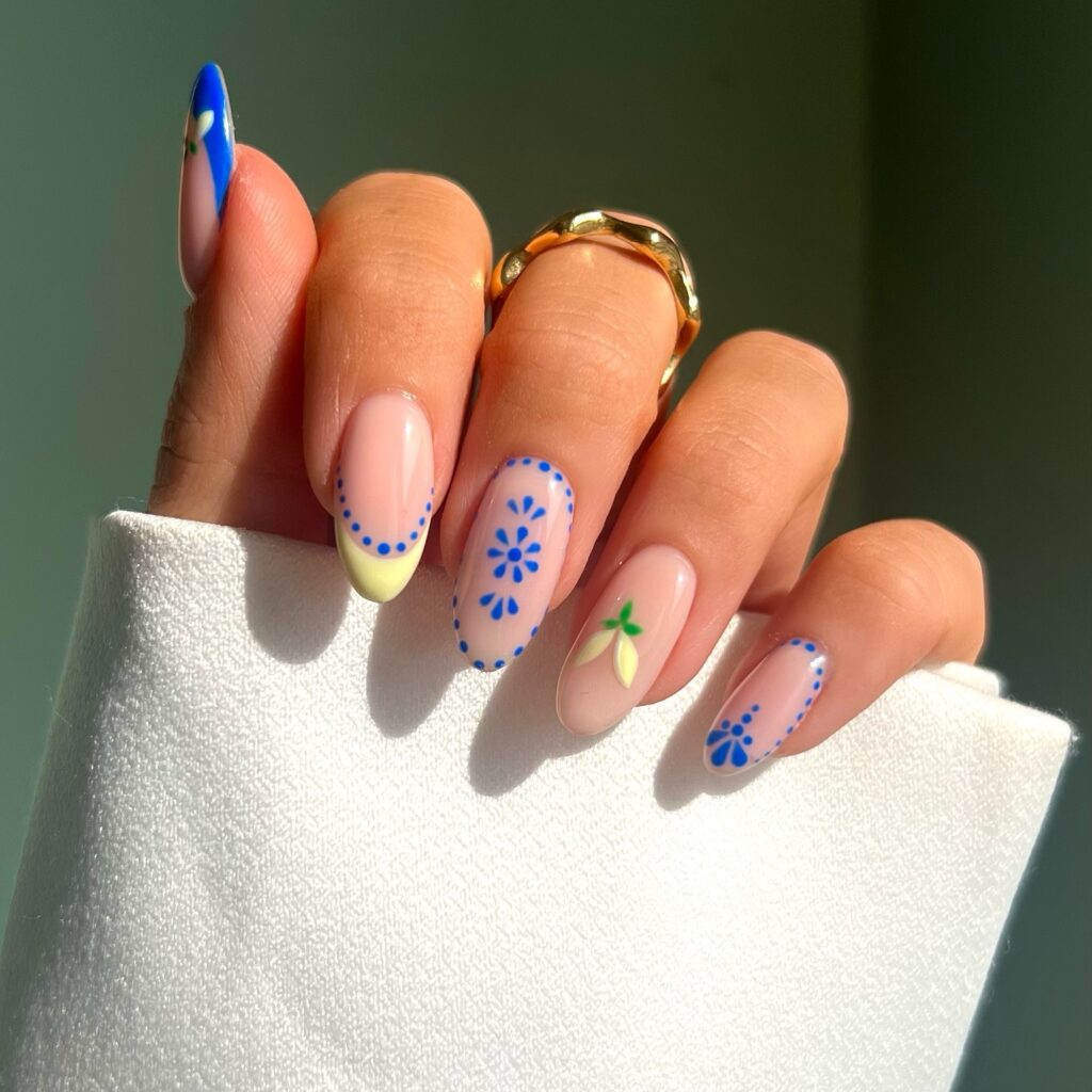 nails with cobalt blue folk art daisies and a yellow French tip