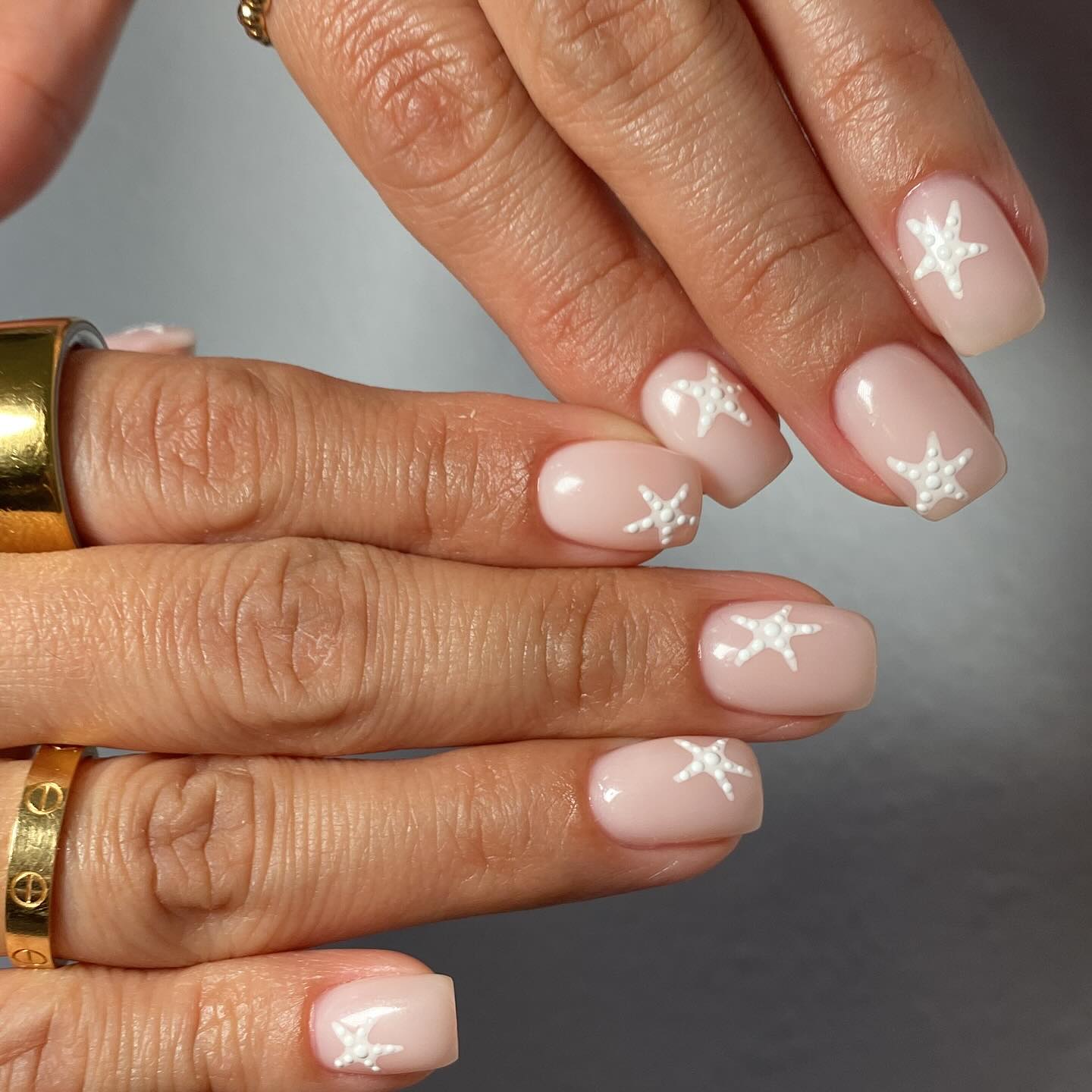 Nude square nails with raised white 3D starfish