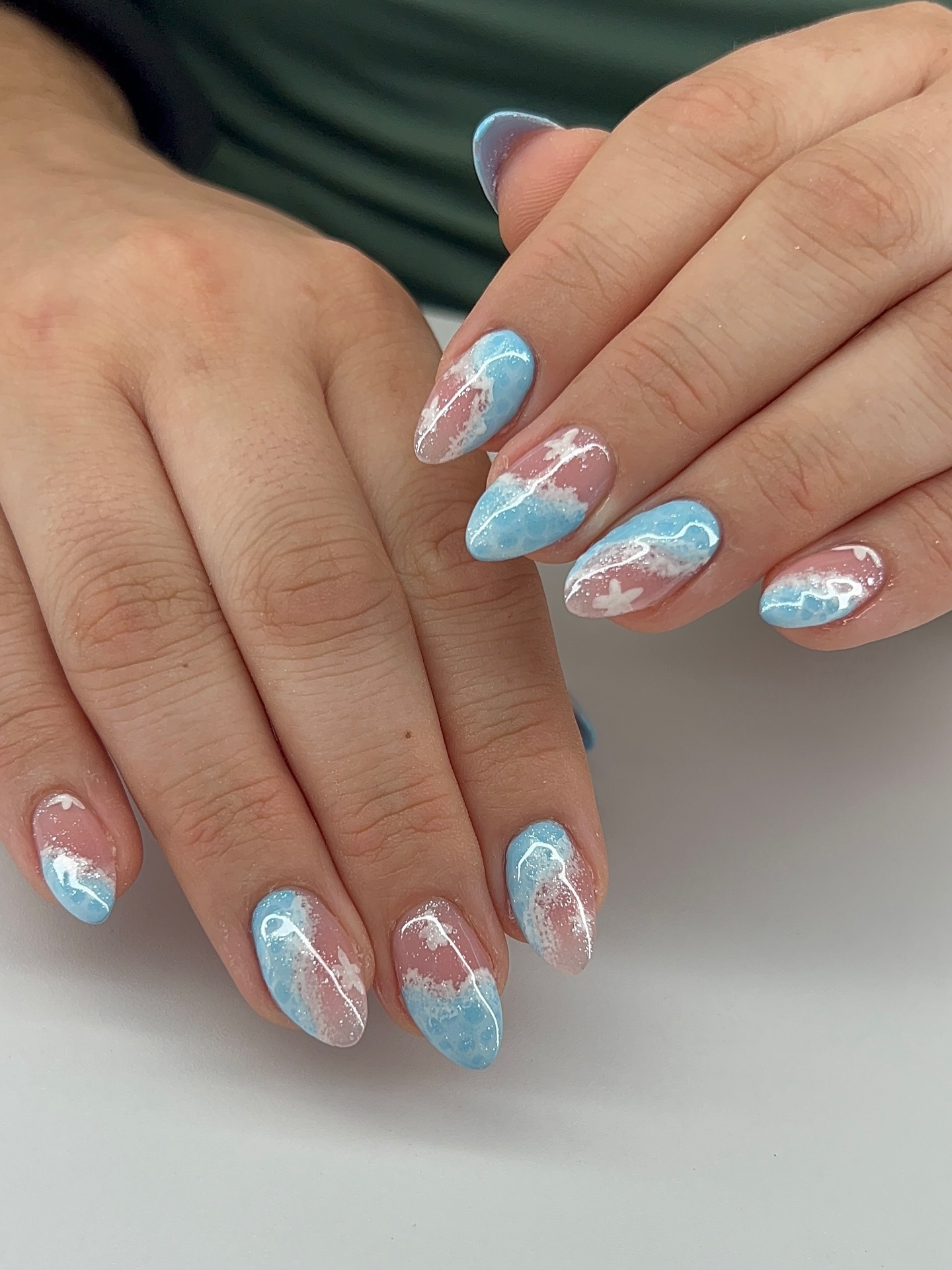 Almond nails with painted ocean wave and sandy beach ombre