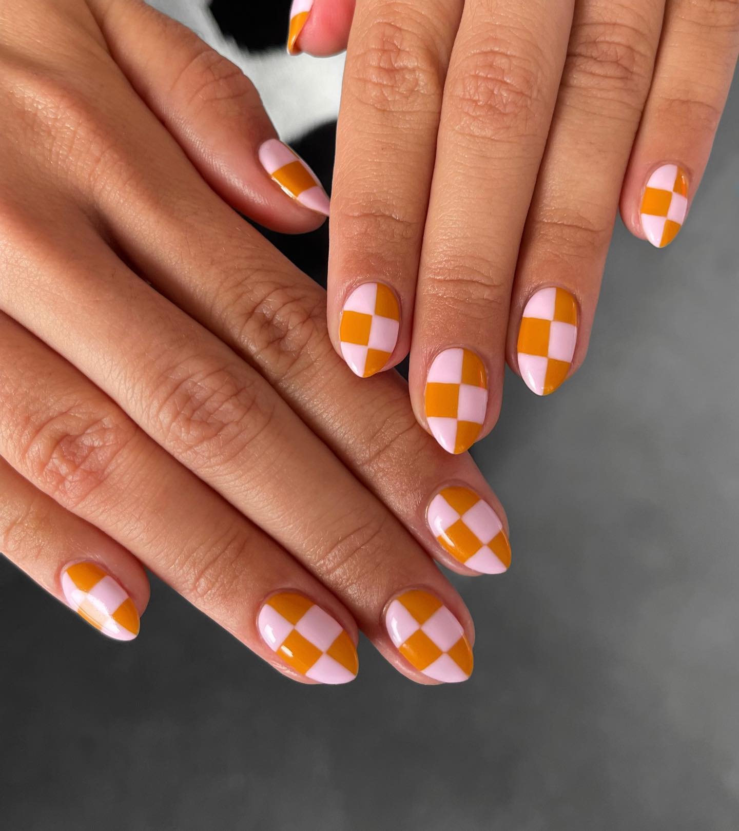 Orange pink checkerboard nails