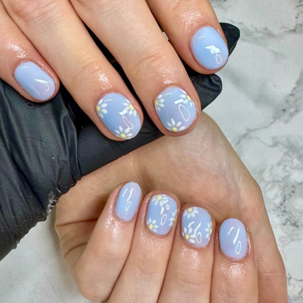 periwinkle blue nails with white daisies and swirls