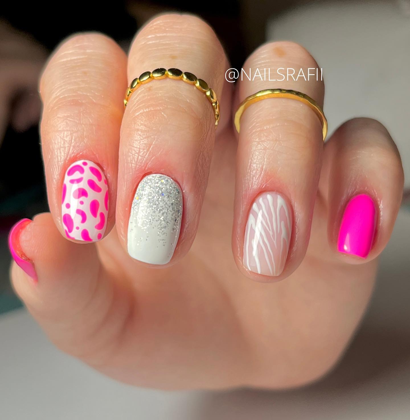 Pink animal print nail art mixed with glitter and white