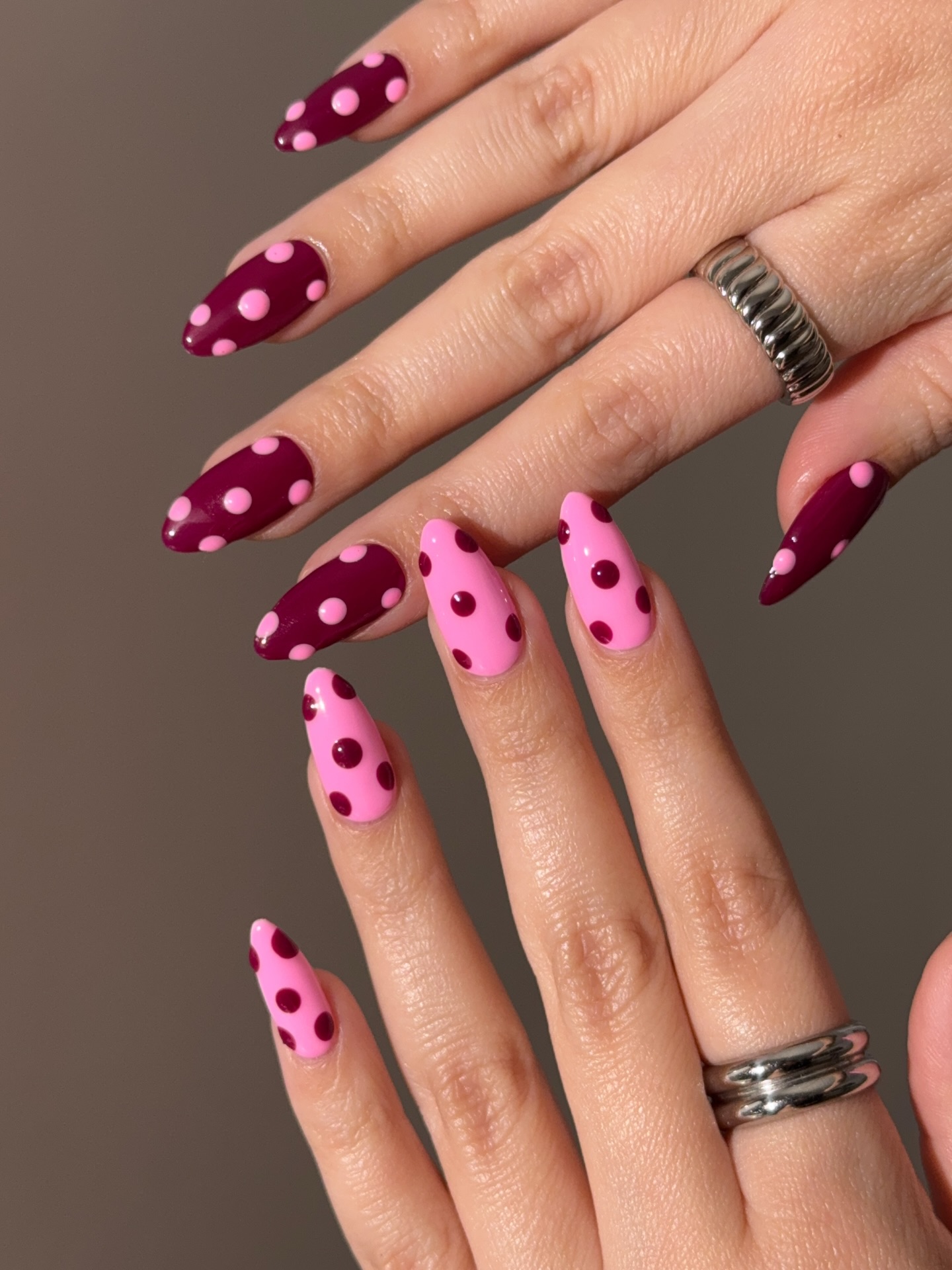 Pink and burgundy contrasting polka dot nails