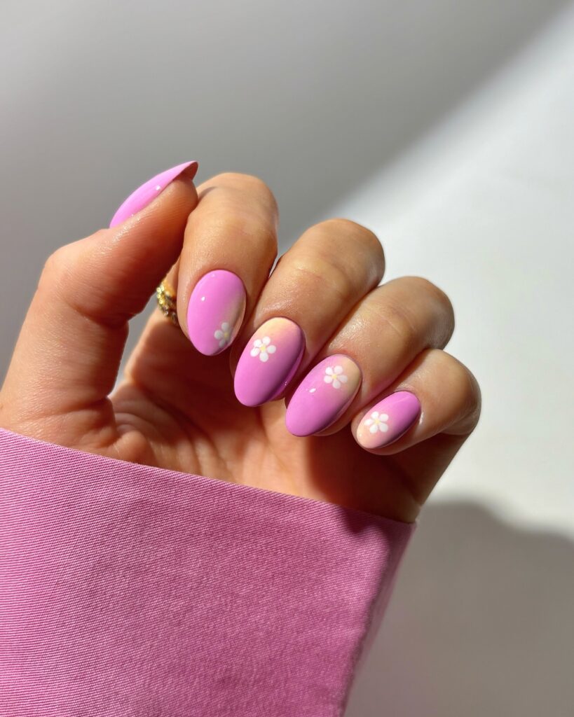 soft pink nails with tiny white daisies on a blush ombre base
