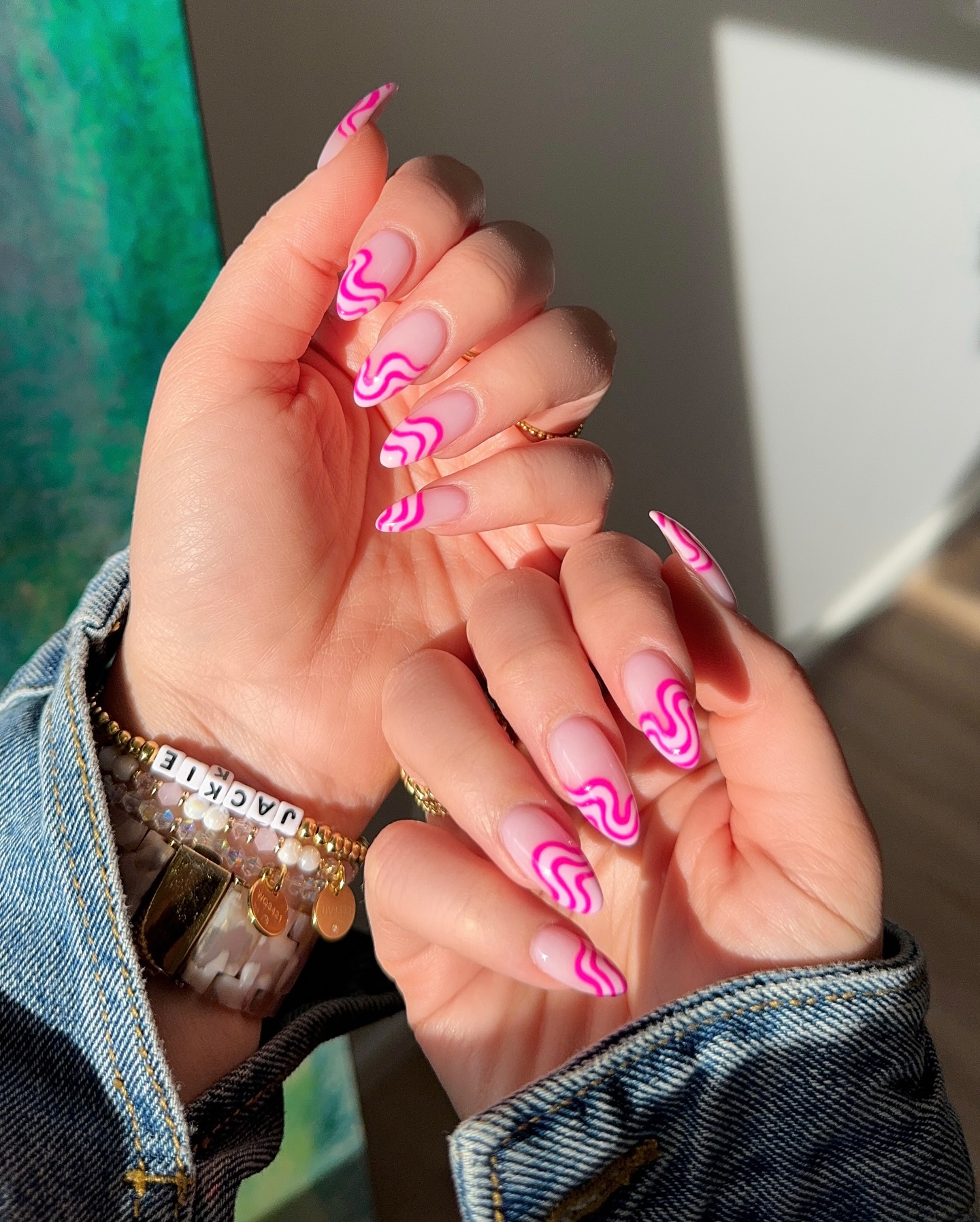 Nude nails with hot pink swirl French tip design