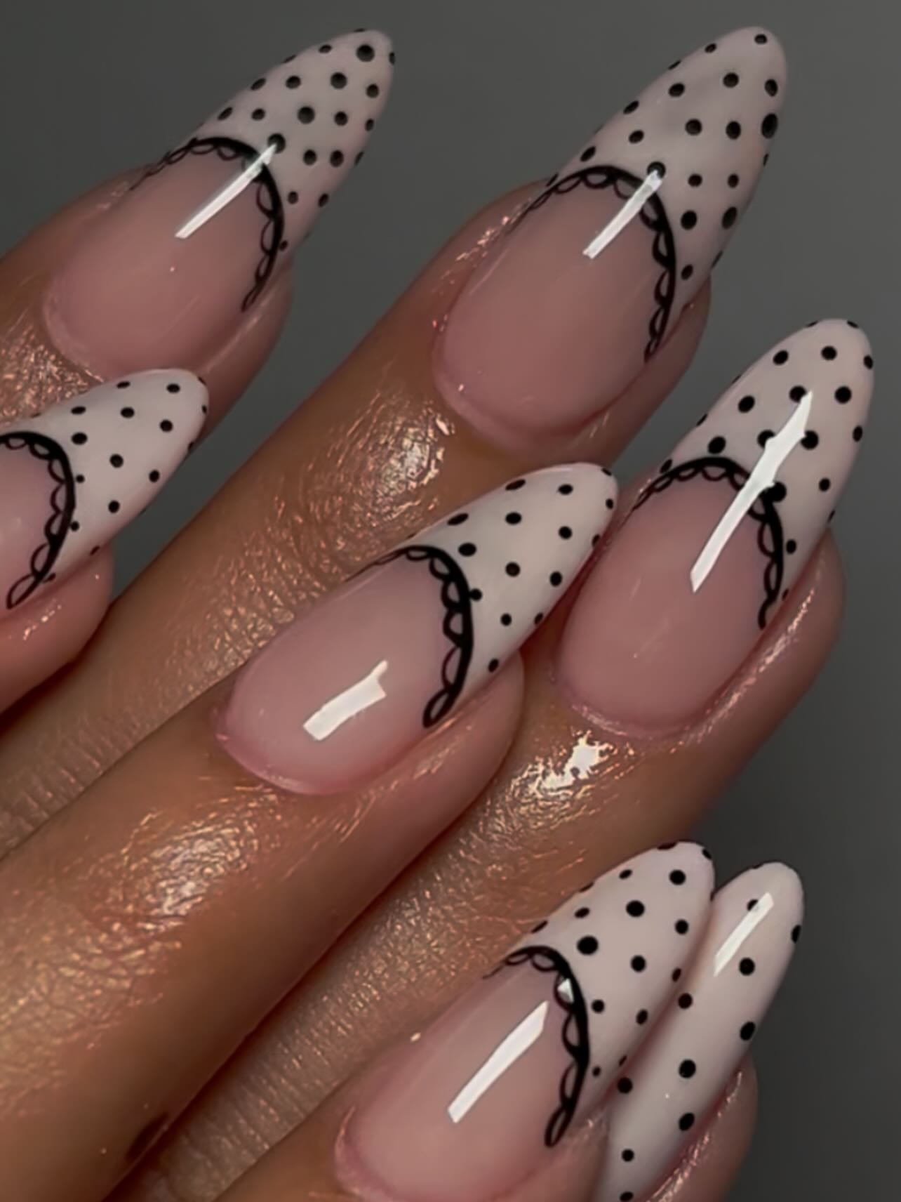 Long stiletto nails with sheer pink base white polka dot French tips and black lace border