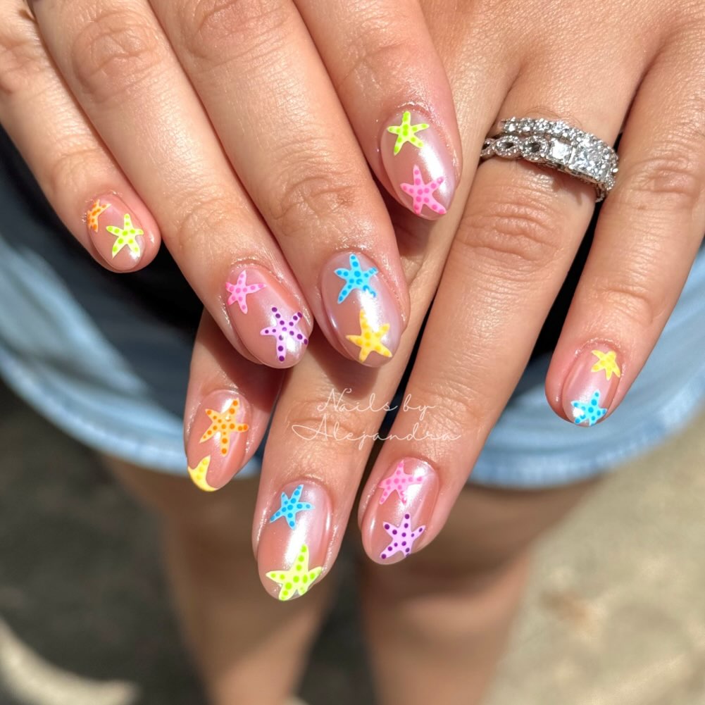 Chrome nails covered in multi-coloured hand-painted starfish