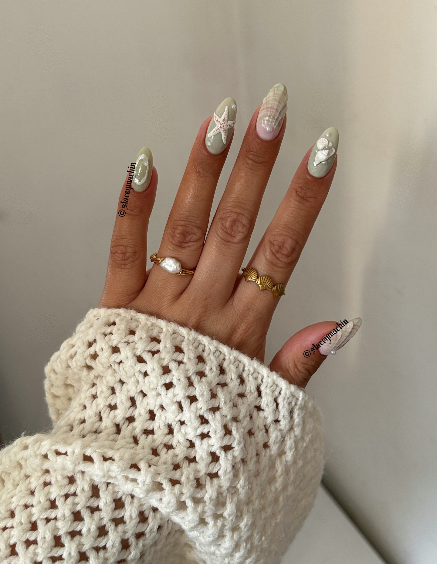Sage green almond nails with 3D starfish and pearl shells