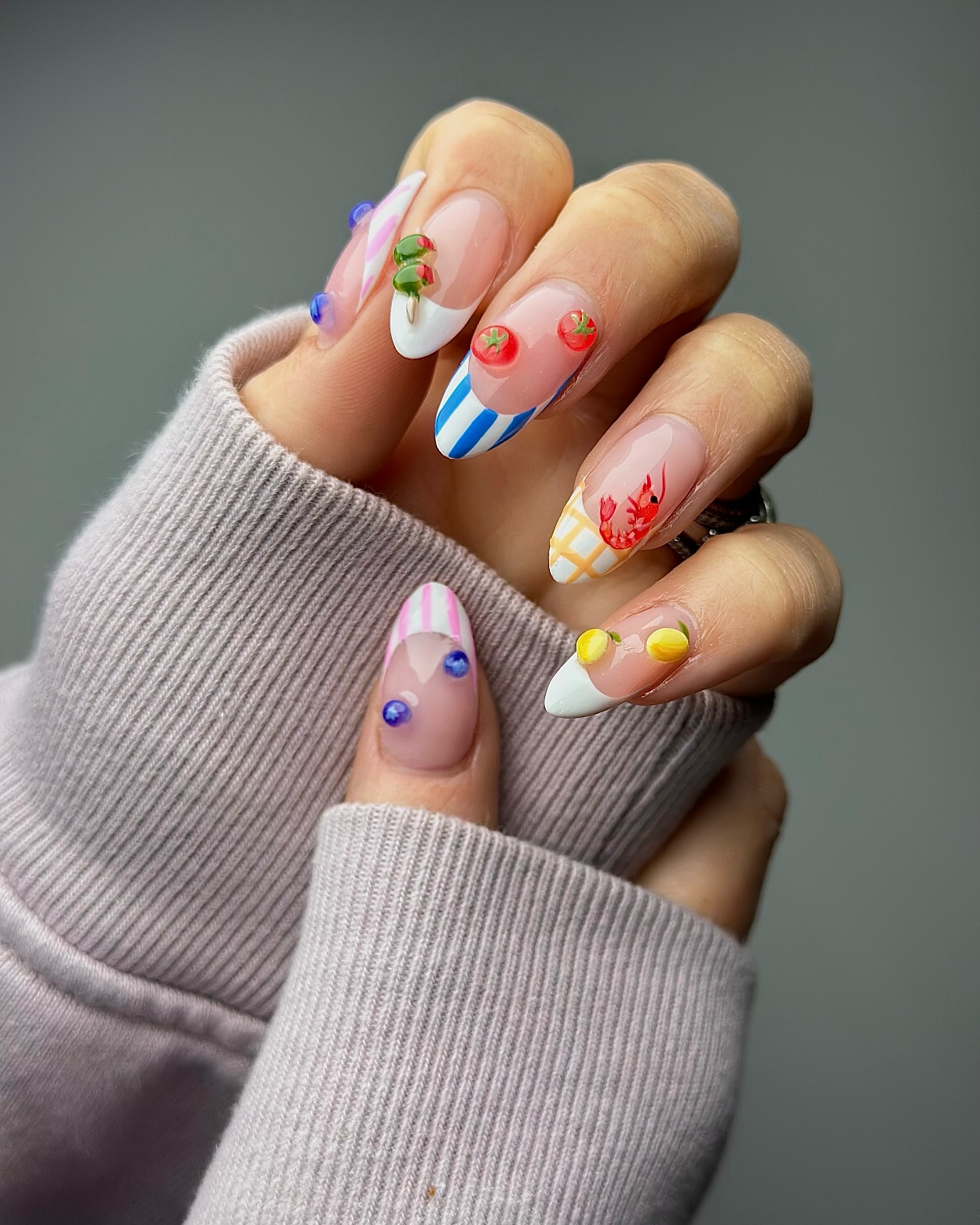 Sheer almond nails with tomato lobster and lemon mismatch art