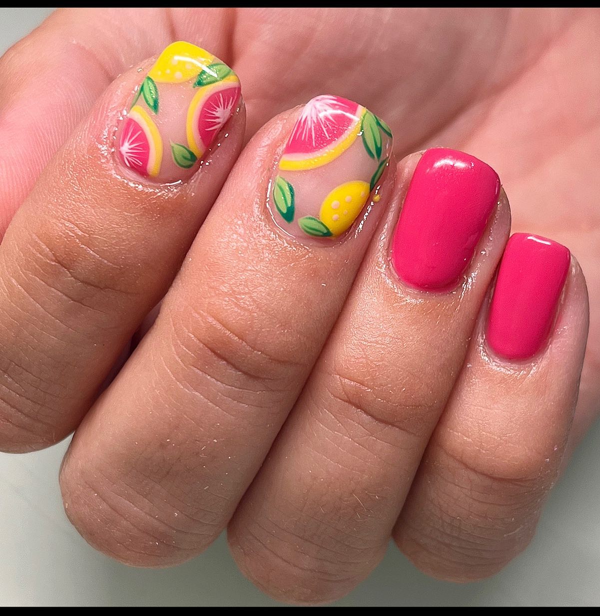 Sheer nude nails with painted lemon and grapefruit art