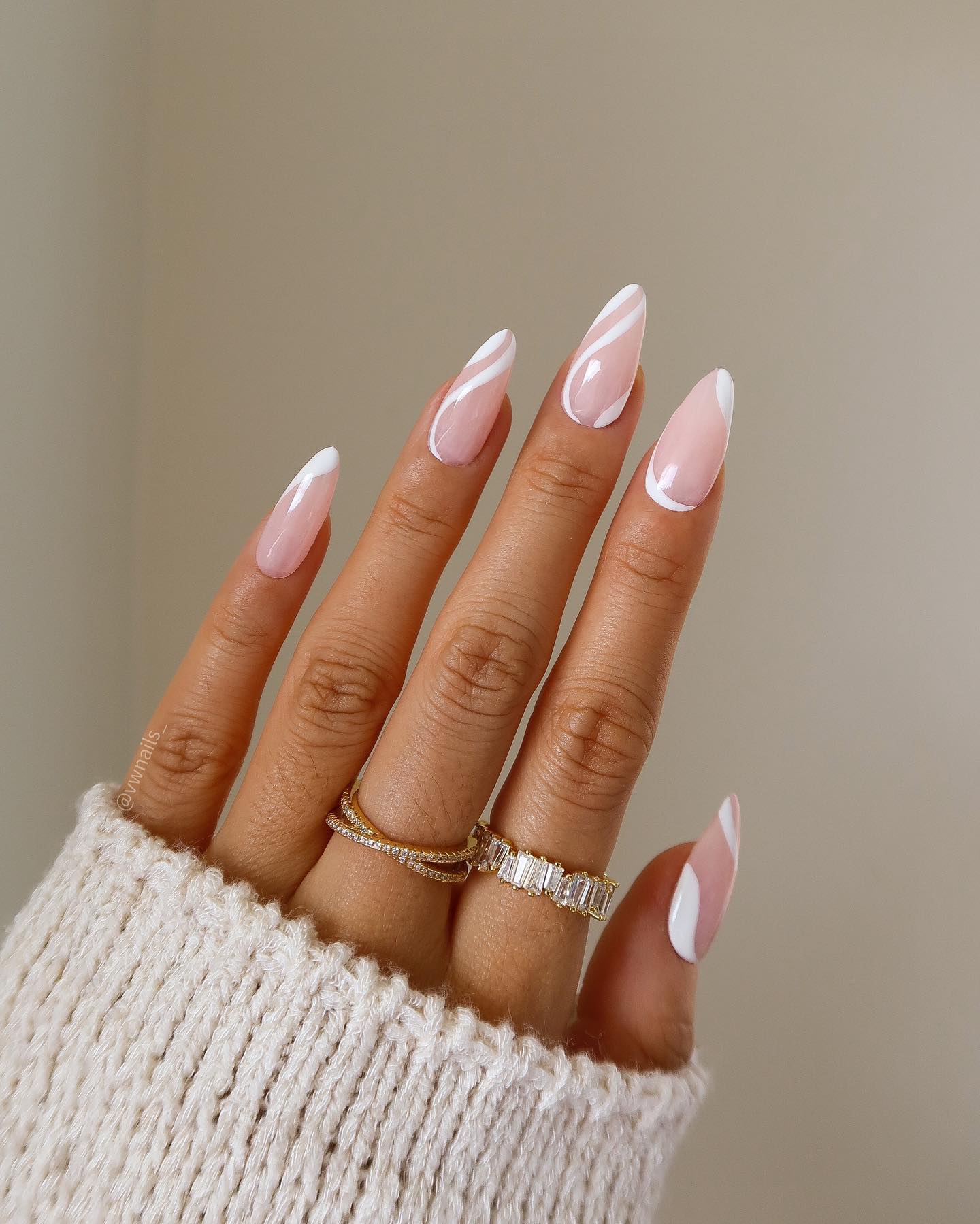 Sheer pink almond nails with bold white freehand swirl overlay by Vivian Marie Wong