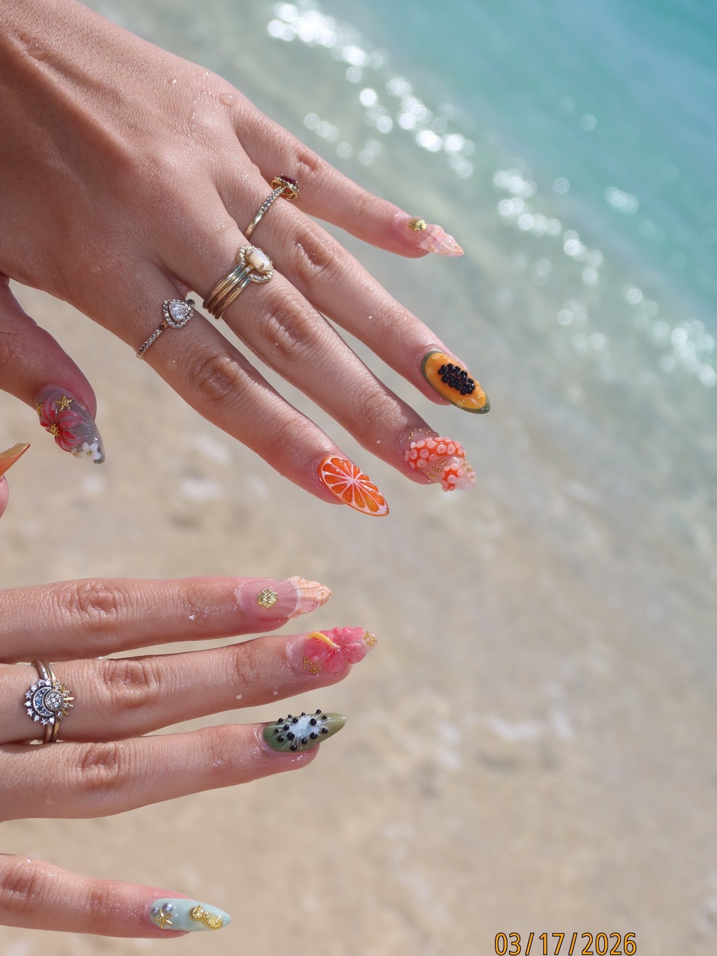 Almond nails with tropical fruit art at the beach