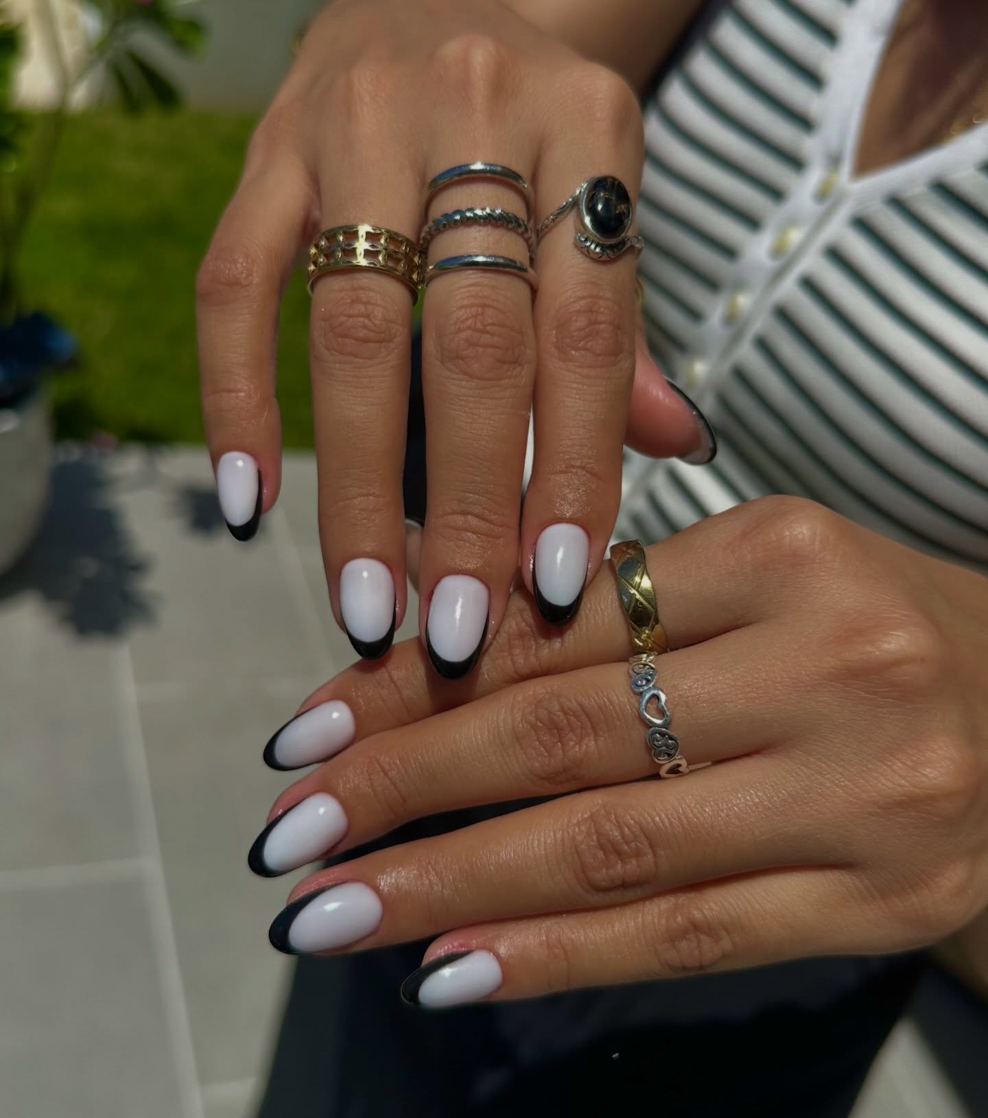 Almond nails with white base and bold black French tip