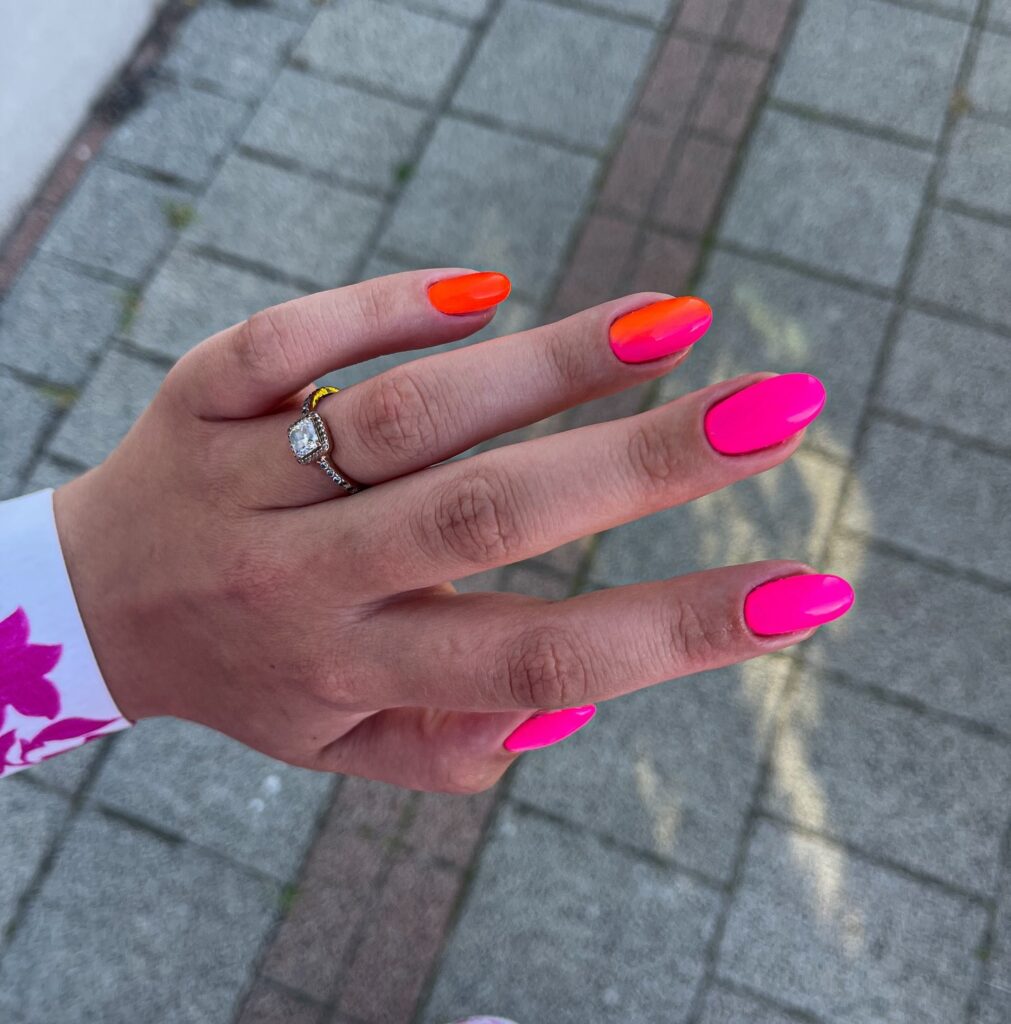Long almond nails with a deep purple to lavender glitter ombre gradient
