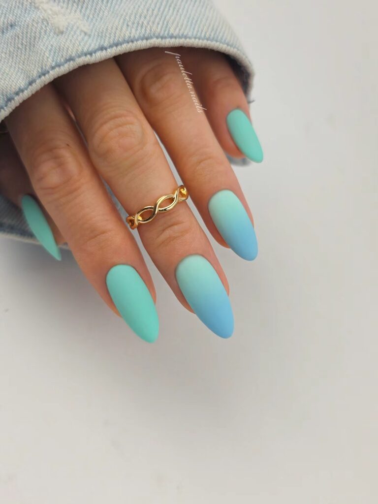 Long almond nails with a matte mint green to sky blue ombre gradient