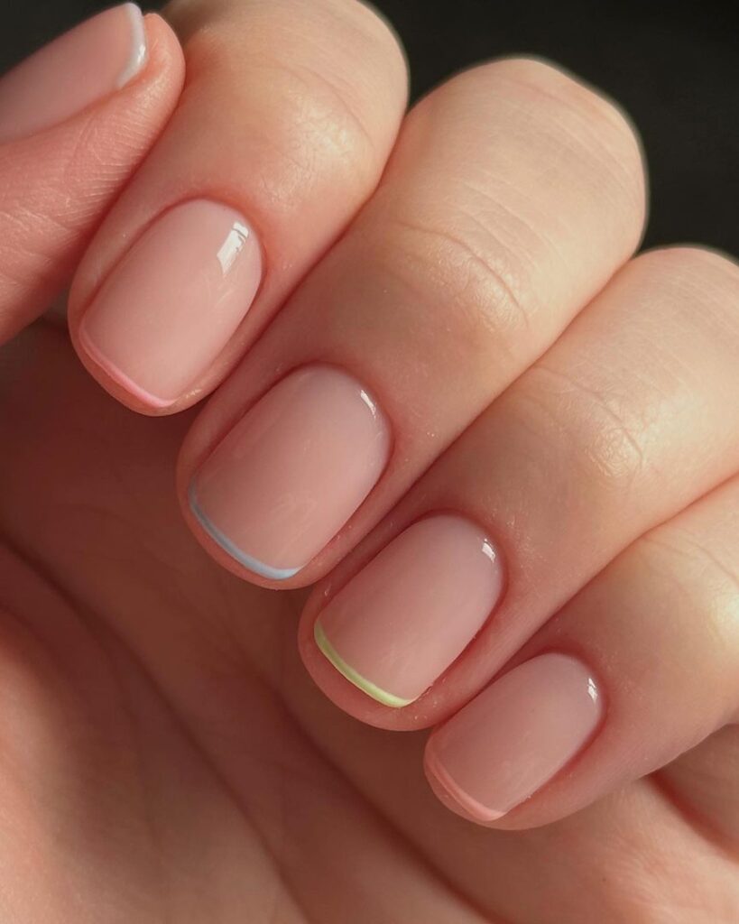 Short square nails with ultra-thin single-line French tips in pale blue-white and neon yellow-green on a sheer base