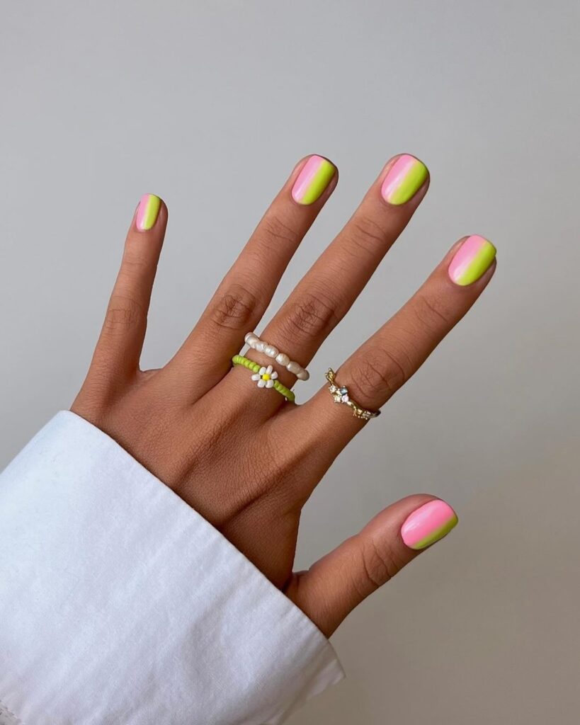 Short square nails with a vertical neon pink and lime green ombre split design